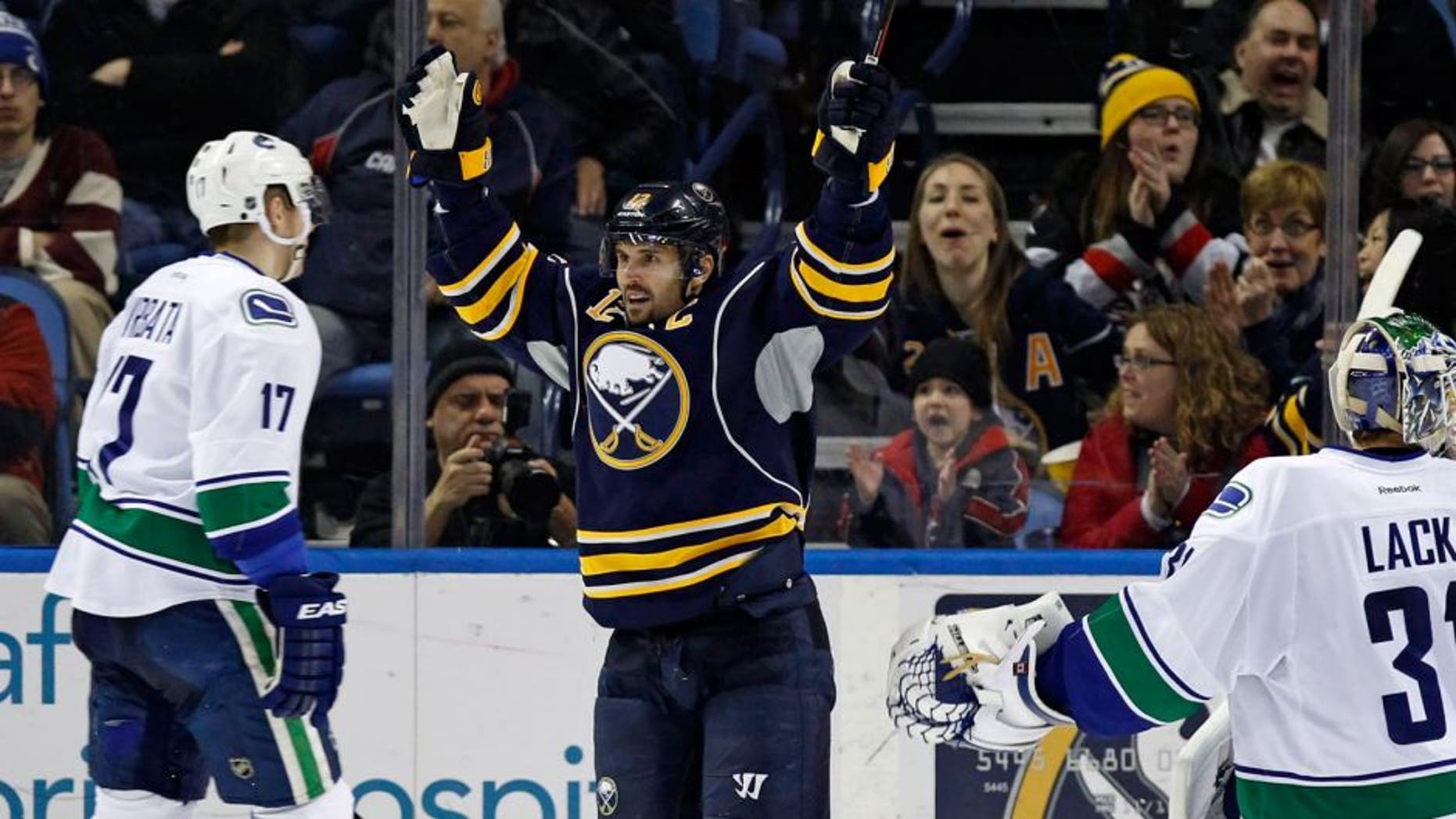 Feb 26, 2015; Buffalo, NY, USA; Buffalo Sabres right wing Brian Gionta (12) celebrates the goal by defenseman Andrej Meszaros (41) (not shown) during the third period at First Niagara Center. Sabres beat the Canucks 6-3. Mandatory Credit: Kevin Hoffman-USA TODAY Sports