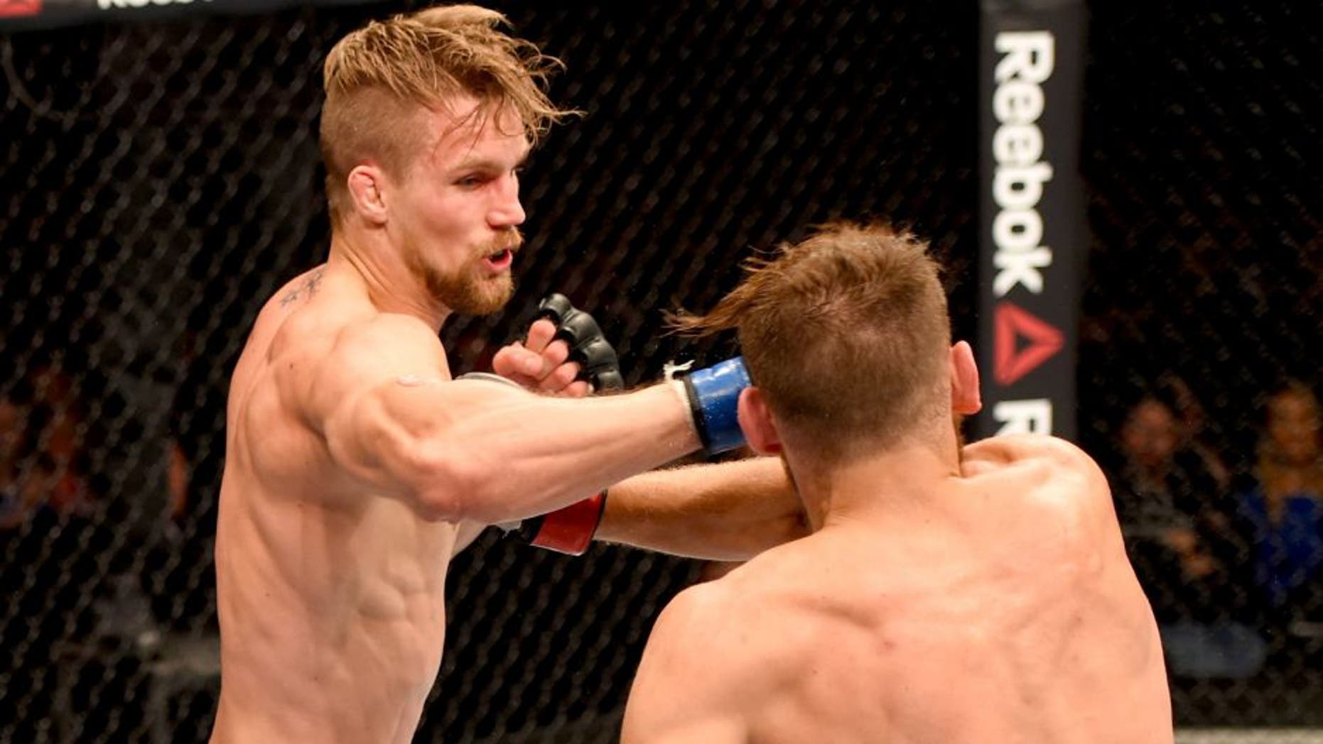 GLASGOW, SCOTLAND - JULY 18: (L-R) Teemu Packalen of Finland punches Mickael Lebout of France in their lightweight fight during the UFC Fight Night event inside the SSE Hydro on July 18, 2015 in Glasgow, Scotland. (Photo by Josh Hedges/Zuffa LLC/Zuffa LLC via Getty Images)