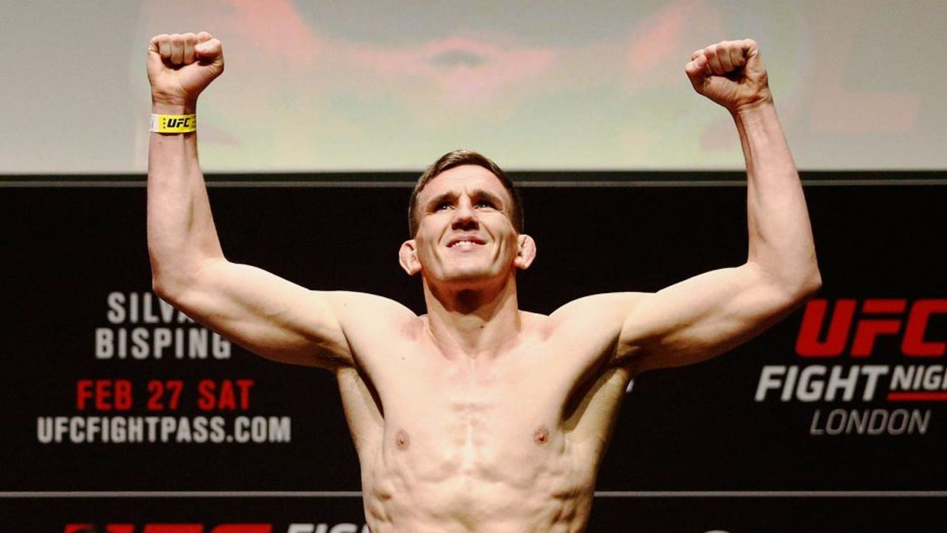 LONDON, ENGLAND - FEBRUARY 26: Scott Askham of England poses on the scales on stage during the UFC Fight Night Weigh-in held at at Indigo at The O2 Arena on February 26, 2016 in London, England. Scott Askham (L) of England and Chris Dempsey (R) of the USA will fight tomorrow night in the O2 Arena. (Photo by Dean Mouhtaropoulos/Zuffa LLC/Zuffa LLC via Getty Images)
