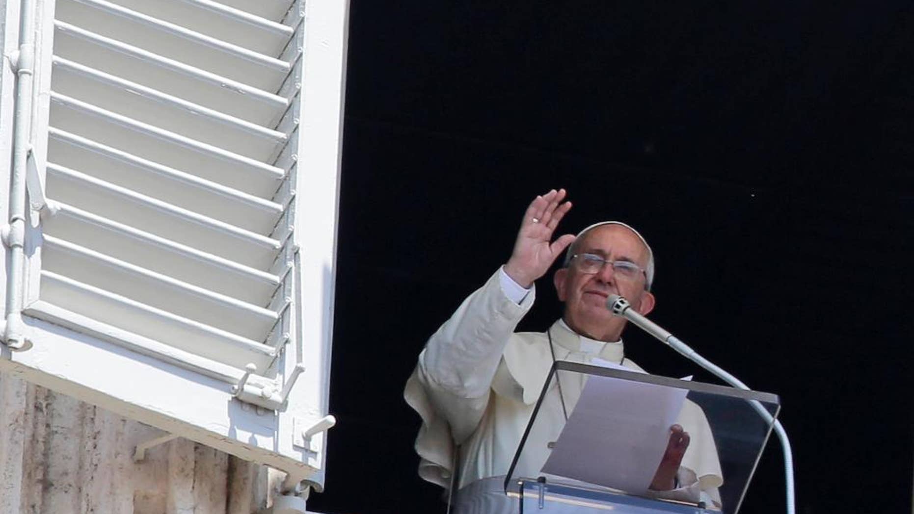 Pope Francis delivers a blessing during the Angelus noon prayer he delivered from his studio's window, in St. Peter's Square, at the Vatican, Sunday, July 19, 2015. Speaking from his studio window, Francis told the crowd Sunday in St. Peter's Square: "I see you are courageous with this heat in the square. A tip of the hat to you!" Many faithful used sun umbrellas. Temperatures in Rome this week could hit 38-39C (100-102F). Sizzling heat and oppressive humidity have gripped Italy this month, with some nights in Rome seeing "low" temperatures hovering near 30C (86F). (AP Photo/Gregorio Borgia)