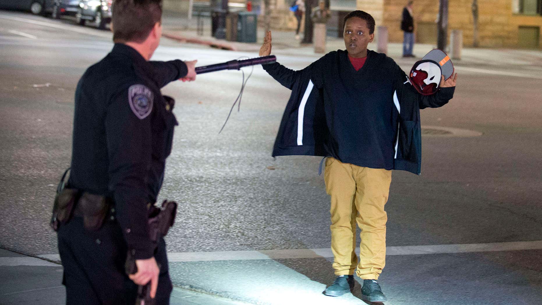 Feb. 27, 2016: Police stop a boy as he walks away from a crowd that formed after an officer-involved shooting at 200 South Rio Grande Street in Salt Lake City.