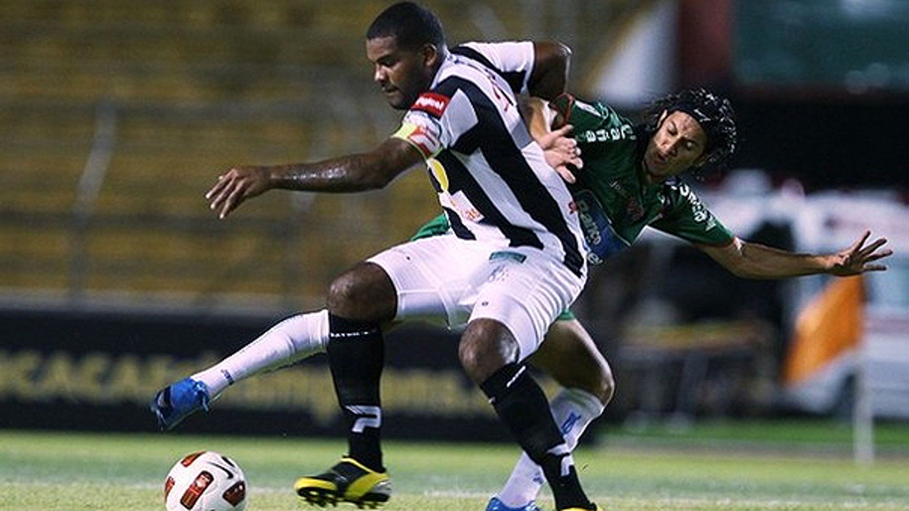 Aug. 4, 2010: s Tauro fights for the ball with Randy Diamond Honduras's Marathon during their CONCACAF Champions League soccer match in San Pedro Sula.