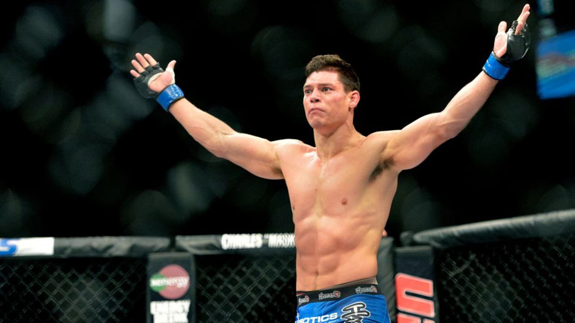 Aug 16, 2014; Bangor, ME, USA;Alan Jouban (blue gloves) celebrates his victory over Seth Baczynski (not pictured) during a welterweight bout in UFC Fight Night 47 at Cross Insurance Center. Mandatory Credit: Gregory J. Fisher-USA TODAY Sports