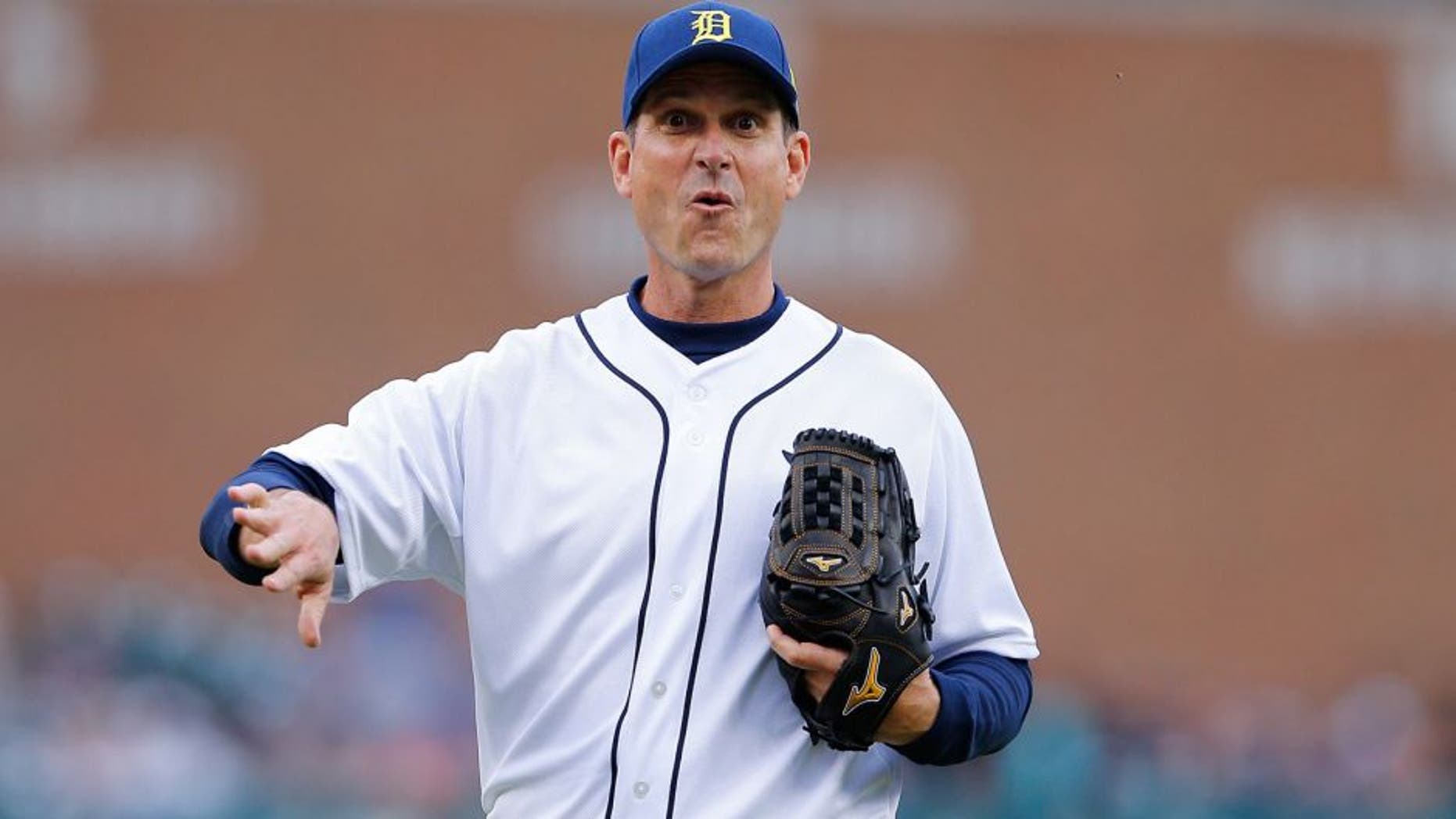 DETROIT, MI - JUNE 30: University of Michigan head football coach Jim Harbaugh throws out the first pitch prior to the start of the interleague game between the Pittsburgh Pirates and the Detroit Tigers play on June 30, 2015 at Comerica Park in Detroit, Michigan. The Pirates defeated the Tigers 5-4 in fourteen innings. (Photo by Leon Halip/Getty Images)