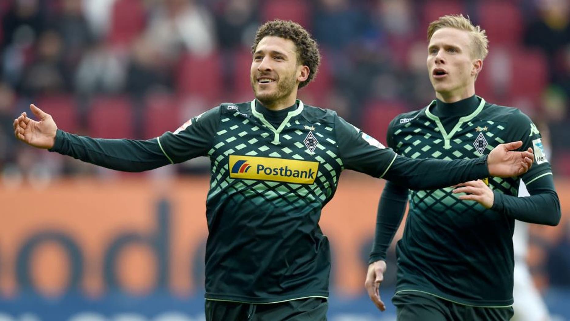 Moenchengladbach's US defender Fabian Johnson (L) and Moenchengladbach's Swedish defender Oscar Wendt celebrate after the second goal for Moenchengladbach during the German first division Bundesliga football match of FC Augsburg vs Borussia Moenchengladbach in Augsburg, southern Germany, on February 28, 2016. / AFP / CHRISTOF STACHE / RESTRICTIONS: DURING MATCH TIME: DFL RULES TO LIMIT THE ONLINE USAGE TO 15 PICTURES PER MATCH AND FORBID IMAGE SEQUENCES TO SIMULATE VIDEO. == RESTRICTED TO EDITORIAL USE == FOR FURTHER QUERIES PLEASE CONTACT DFL DIRECTLY AT + 49 69 650050 (Photo credit should read CHRISTOF STACHE/AFP/Getty Images)