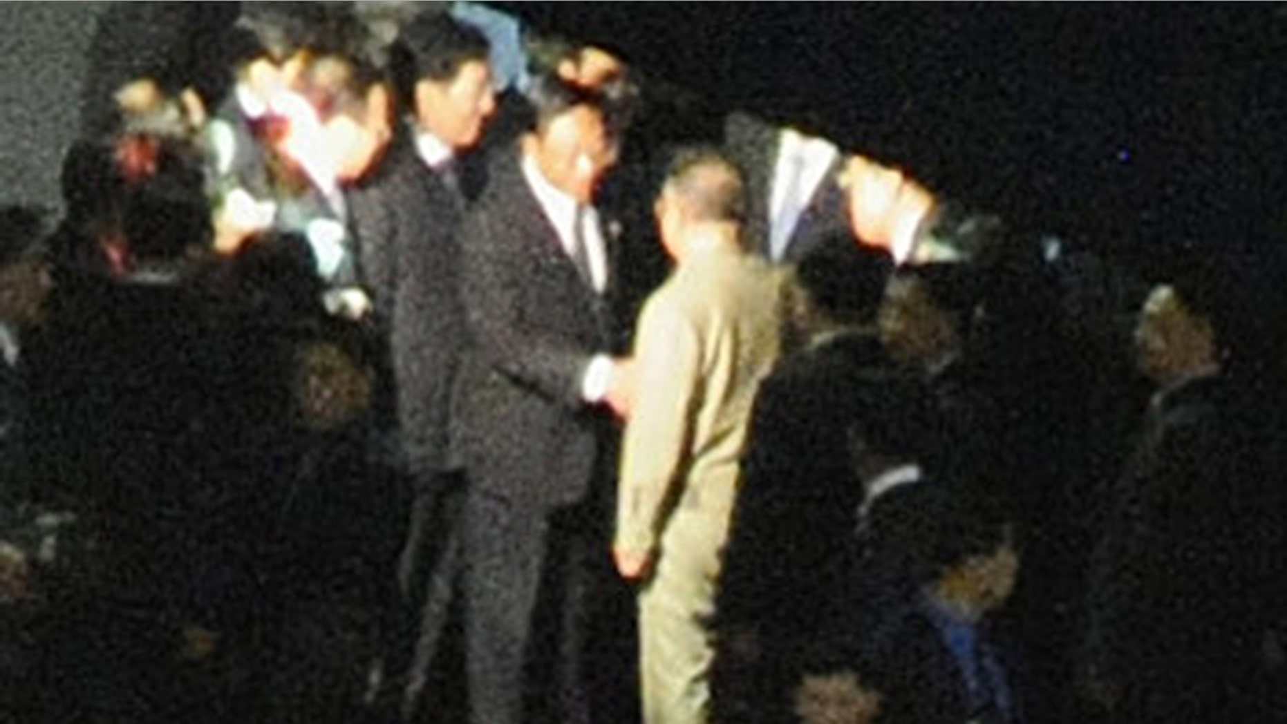 Aug. 28: A man, believed to be North Korean leader Kim Jong Il, center facing away from camera, is greeted at Changchun rail station in Changchun, China.