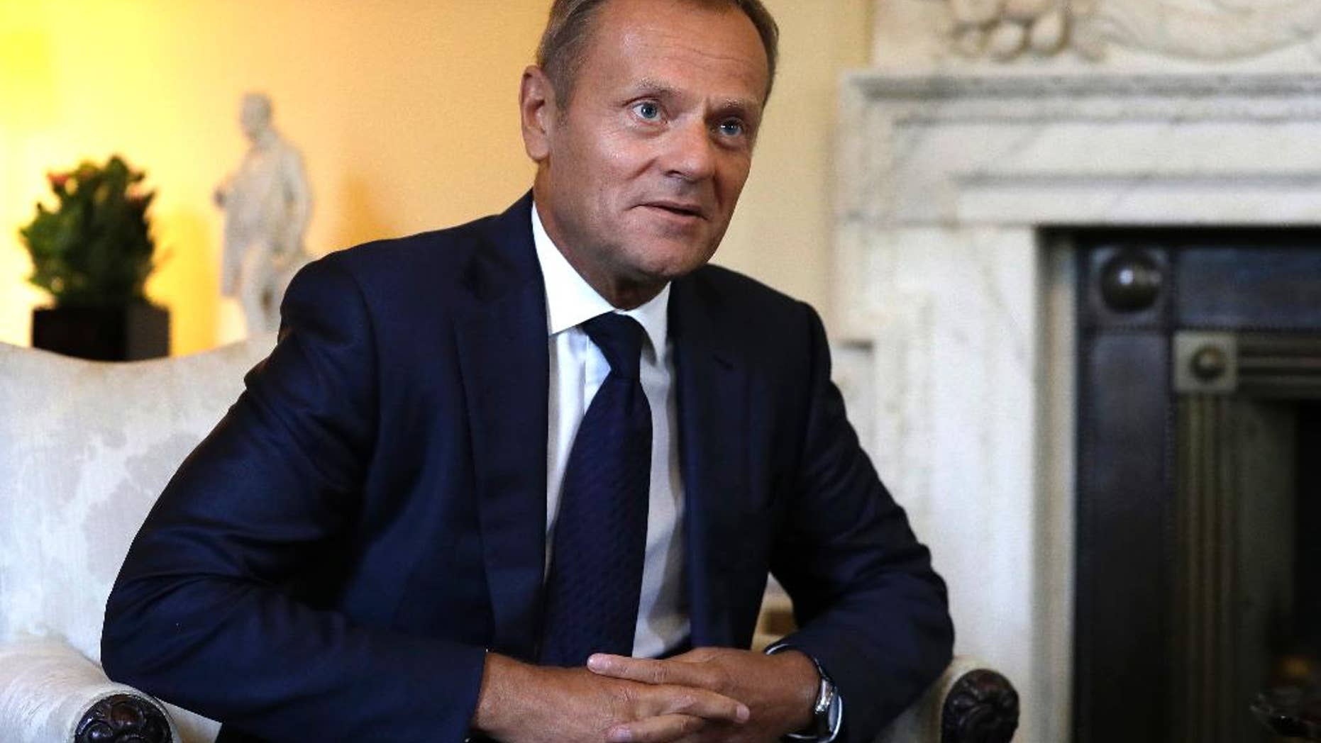 President of the European Council, Donald Tusk listens to Britain's Prime Minister Theresa May inside 10 Downing Street in London, Thursday, Sept. 8, 2016. The two met for a bilateral meeting to discuss Brexit, amid increasing pressure over a lack of detail in the Government's stated strategy. (AP Photo/Kirsty Wigglesworth, pool)