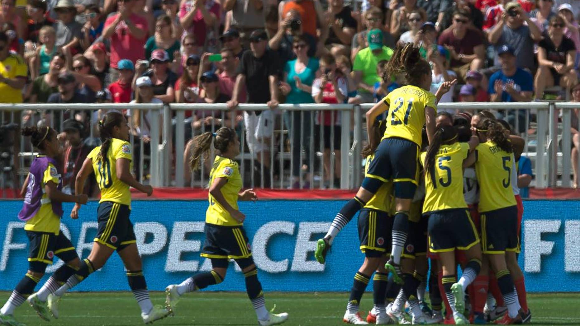 Colombia celebrates their 2-0 victory over France in a FIFA Women's World Cup soccer game in Moncton, New Brunswick, Canada, on Saturday, June 13, 2015. (Andrew Vaughan/The Canadian Press via AP) MANDATORY CREDIT