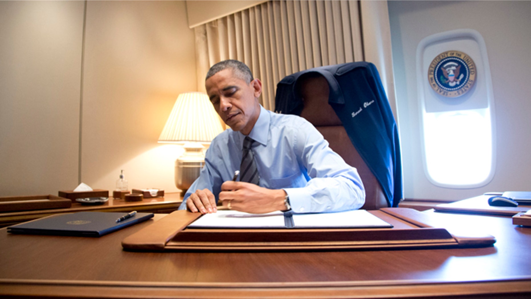 President Obama signed presidential memoranda associated with his actions on immigration on Air Force One.