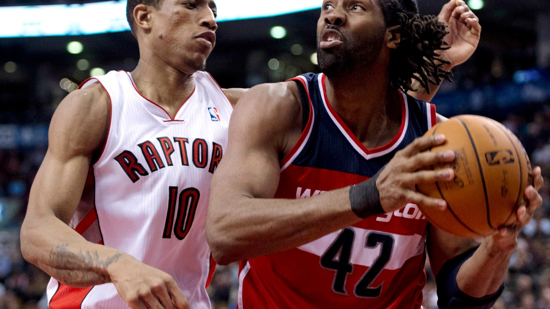 Toronto Raptors guard DeMar DeRozan (10) defends against Washinton Wizards center Nene (42) during the second half of their NBA basketball game, Monday, Feb. 25, 2013, in Toronto. The Wizards won 90-84. (AP Photo/The Canadian Press, Frank Gunn)