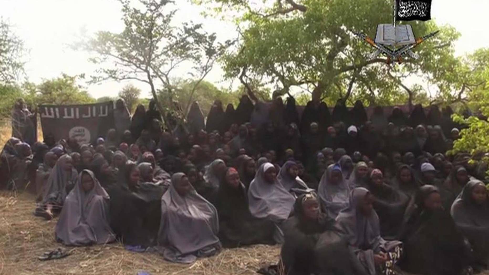 FILE-In this file photo taken from video released by Nigeria's Boko Haram terrorist network, Monday May 12, 2014, shows missing girls abducted from the northeastern town of Chibok. A teenage who surrendered before carrying out a suicide bombing attack in northern Cameroon has told authorities she was one of the 276 girls abducted from a Nigerian boarding school by Islamic extremists nearly two years ago, authorities said Saturday, March 26, 2016. (AP Photo)