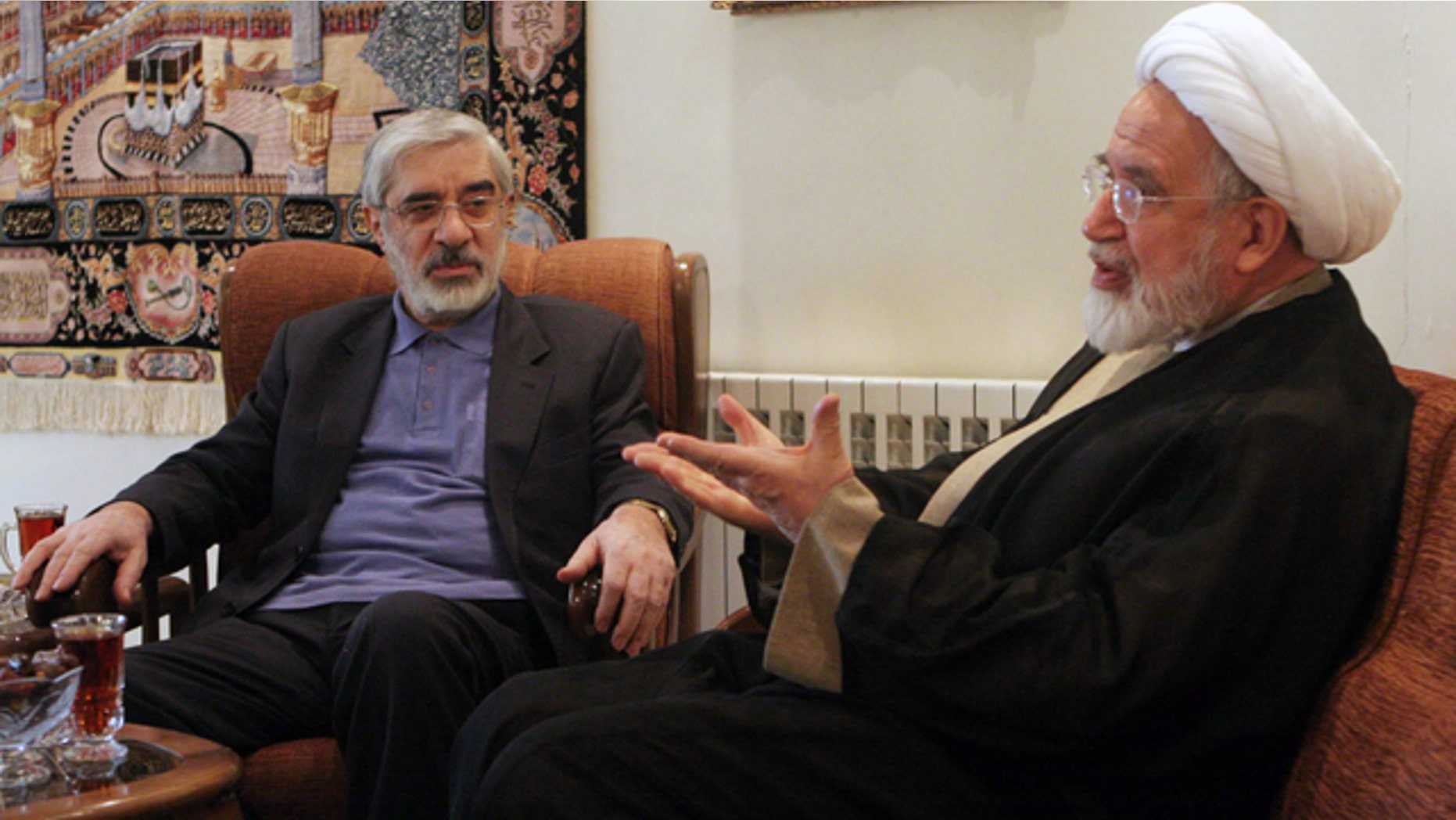 In this Saturday, Oct. 10, 2009, file photo, leaders of Iranian opposition, Mahdi Karroubi, right, and Mir Hossein Mousavi talk in Tehran, Iran.