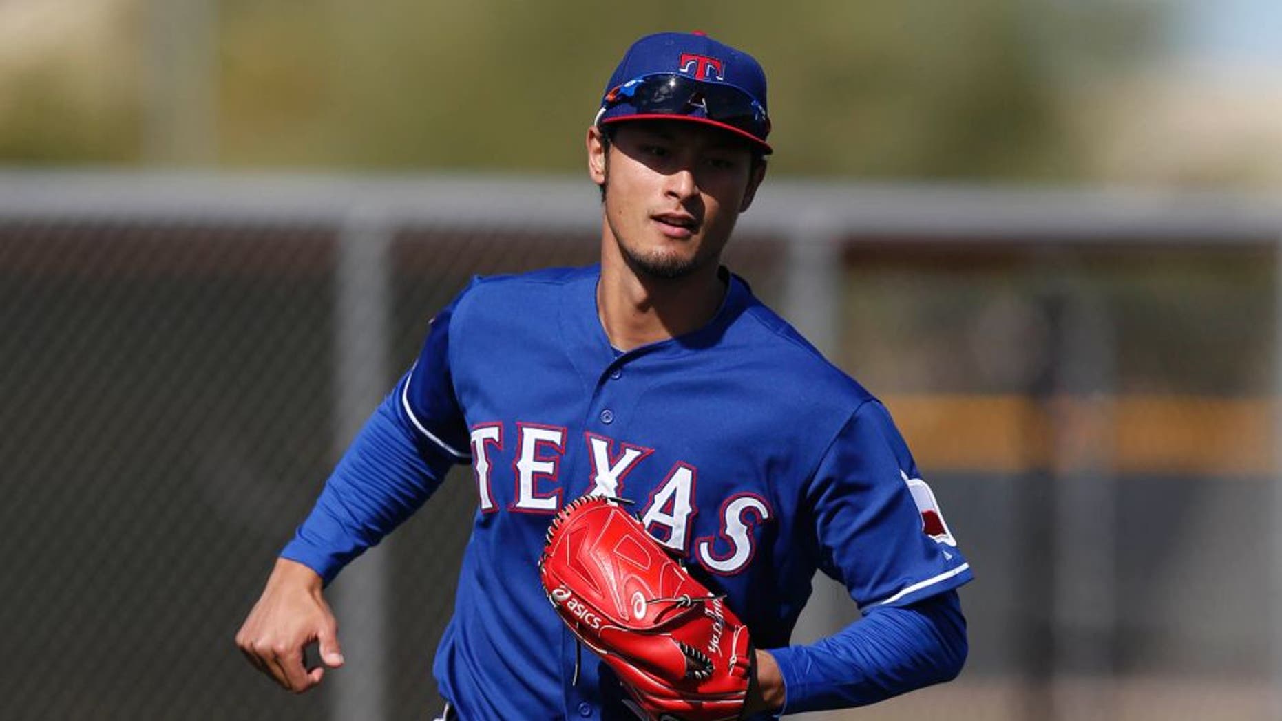 Feb 24, 2015; Surprise, AZ, USA; Texas Rangers starting pitcher Yu Darvish (11) fields grounders during spring training camp at Surprise Stadium. Mandatory Credit: Rick Scuteri-USA TODAY Sports