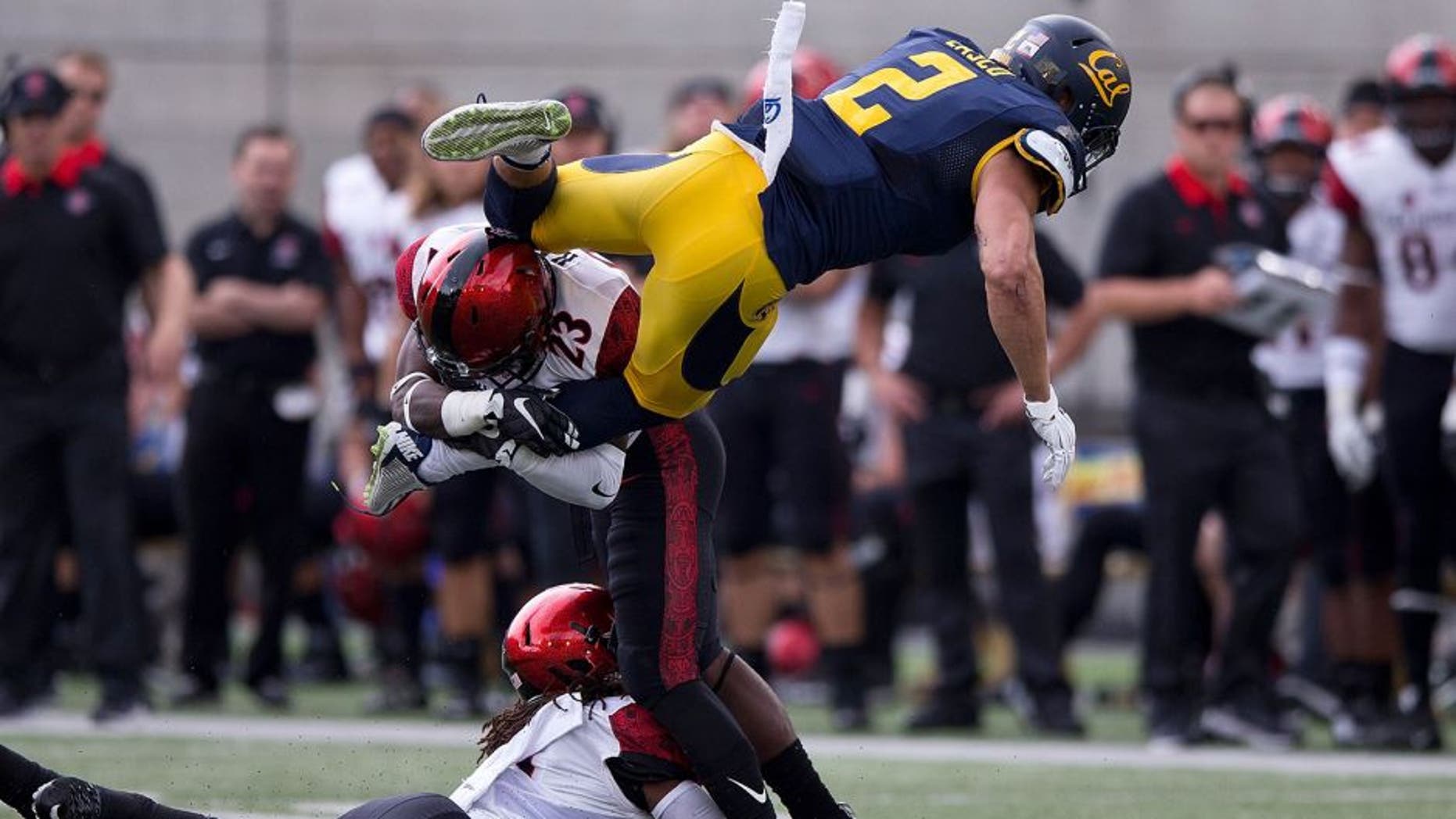 BERKELEY, CA - SEPTEMBER 12: Running back Daniel Lasco #2 of the California Golden Bears jumps past defensive back Na'im McGee #21 of the San Diego State Aztecs into defensive back Damontae Kazee #23 during the first quarter at California Memorial Stadium on September 12, 2015 in Berkeley, California. The California Golden Bears defeated the San Diego State Aztecs 35-7. (Photo by Jason O. Watson/Getty Images)