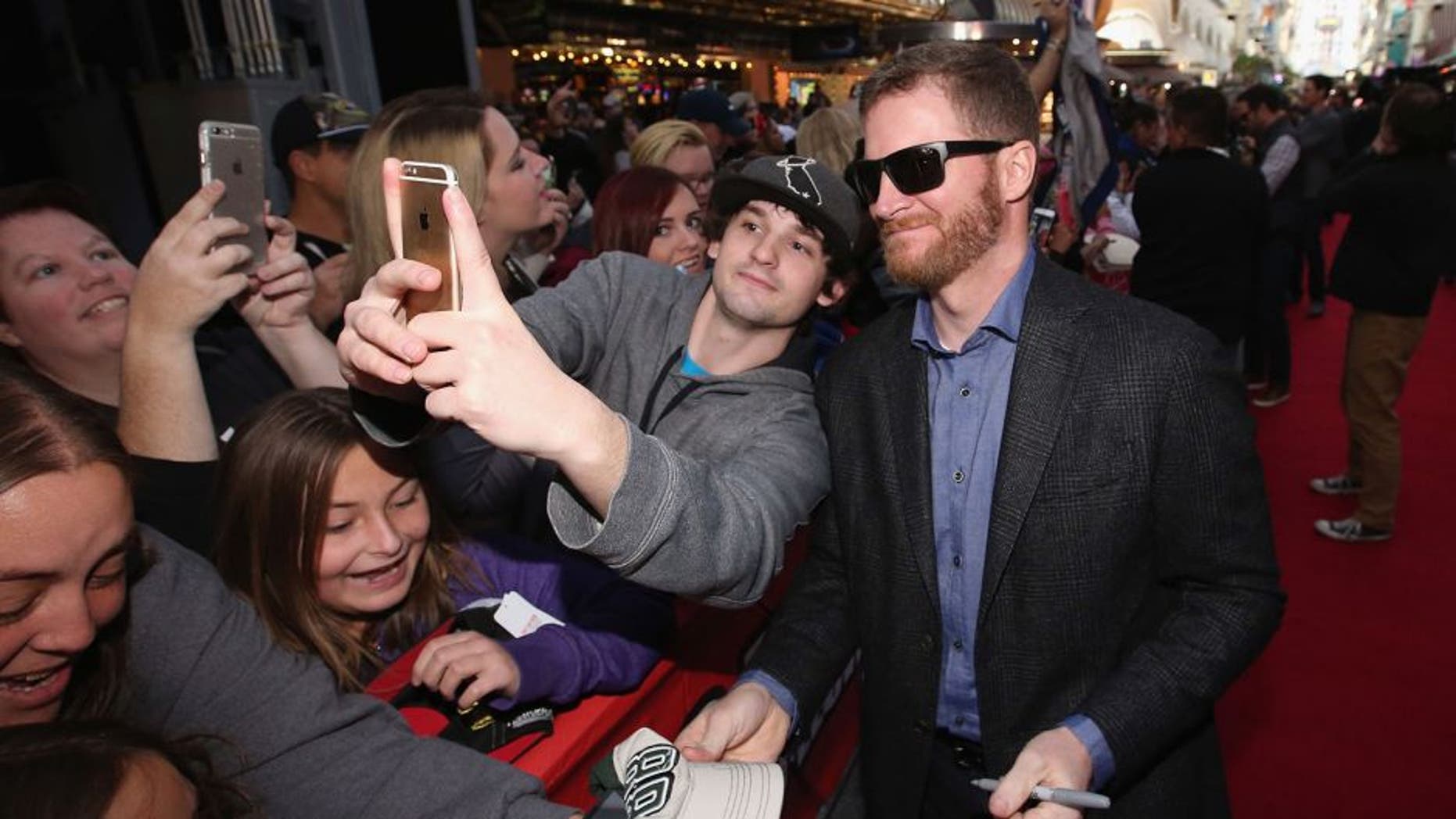 LAS VEGAS, NV - DECEMBER 02: NASCAR Sprint Cup Series driver Dale Earnhardt Jr. interacts with fans during the NASCAR Sprint Cup Series FanFest hosted by Las Vegas Motor Speedway on the Third Street Stage at the Fremont Street Experience on December 2, 2015 in Las Vegas, Nevada. (Photo by Sean Gardner/NASCAR via Getty Images)