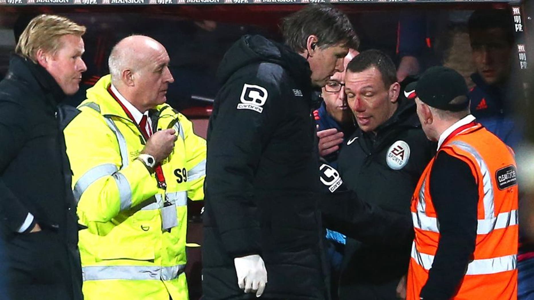 BOURNEMOUTH, ENGLAND - MARCH 01: Blooded fourth official Kevin Friend receives treatment by team staffs during the Barclays Premier League match between A.F.C. Bournemouth and Southampton at Vitality Stadium on March 1, 2016 in Bournemouth, England. (Photo by Michael Steele/Getty Images)