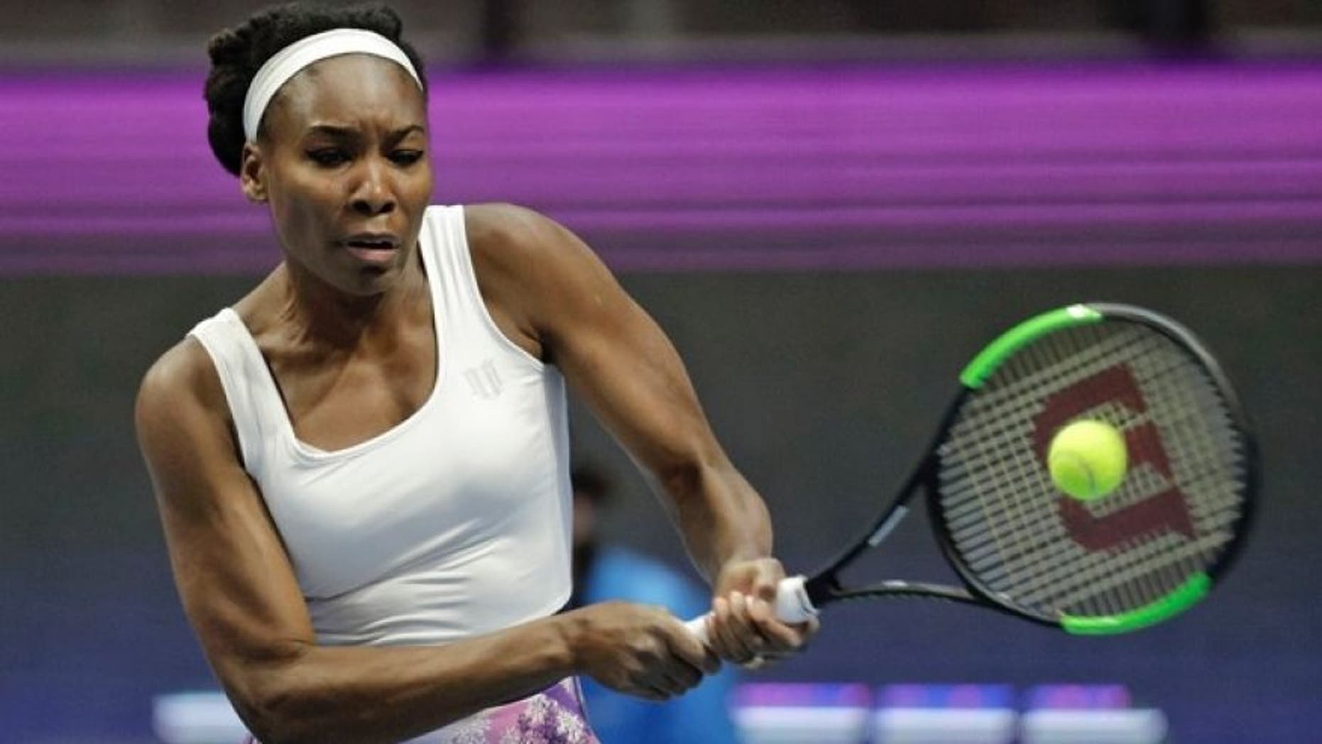 Venus Williams of the U.S. returns the ball to Kristina Mladenovic of France during the St. Petersburg Ladies Trophy-2017 tennis tournament match in St. Petersburg, Russia, Thursday, Feb. 2, 2017.