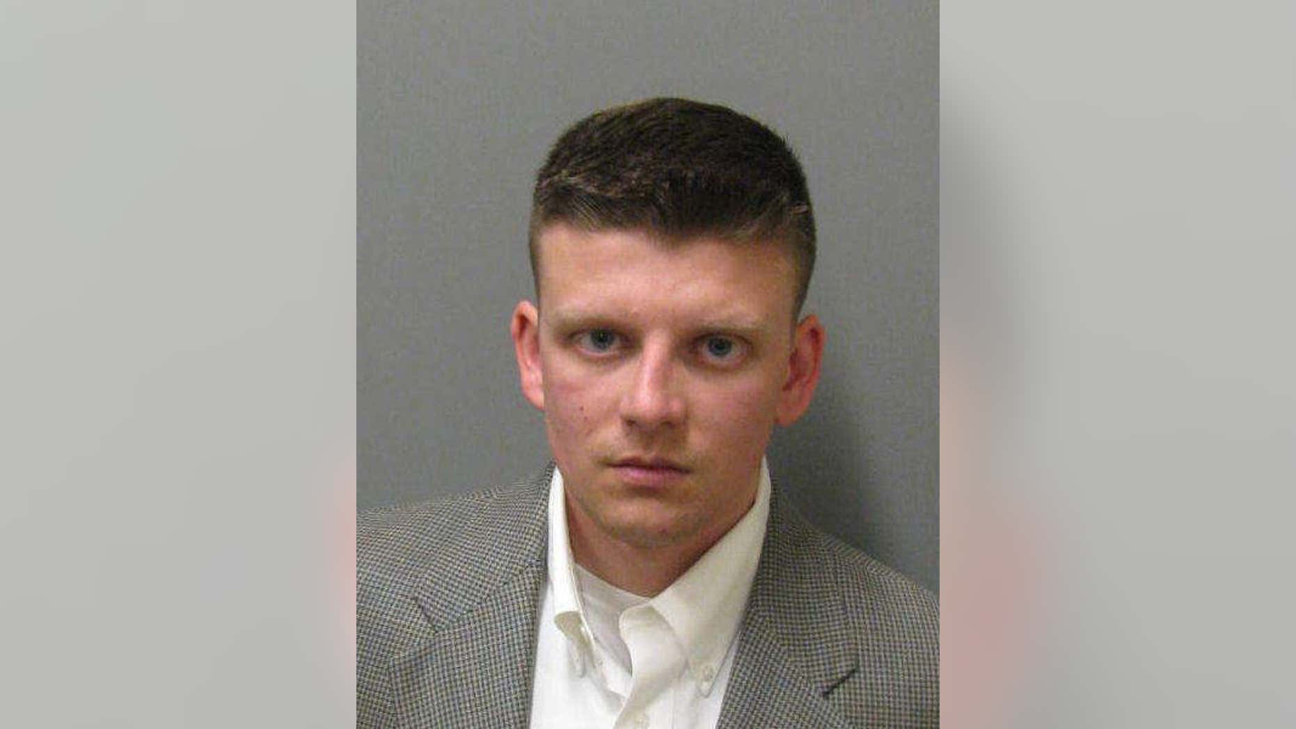 This undated photo provided by the Montgomery County Sheriff's Office shows Montgomery Police officer Aaron Smith. Smith has been charged with murder in the shooting death of a black man, Greg Gunn, outside a neighbor's home.