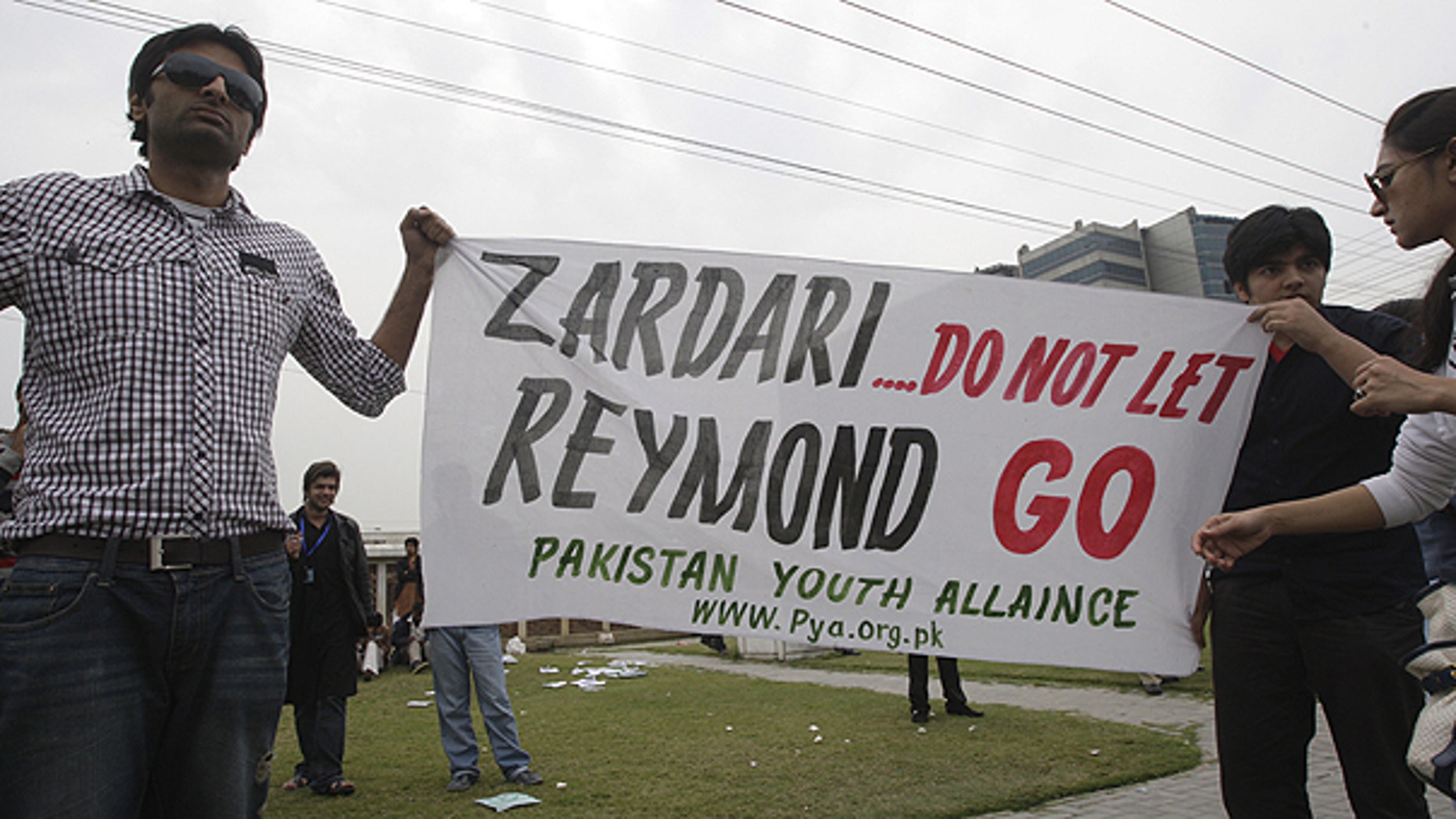 March 3: Pakistani students hold banner in Lahore, Pakistan against American CIA contractor Raymond Allen Davis.