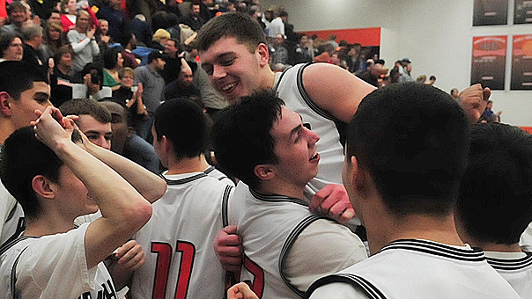 March 3: Teammates hoist Wes Leonard up after he hit the game-winning basket as the Fennville (Mich.) Blackhawks celebrate their victory against the Bridgman Bees, bringing their record to 20-0.