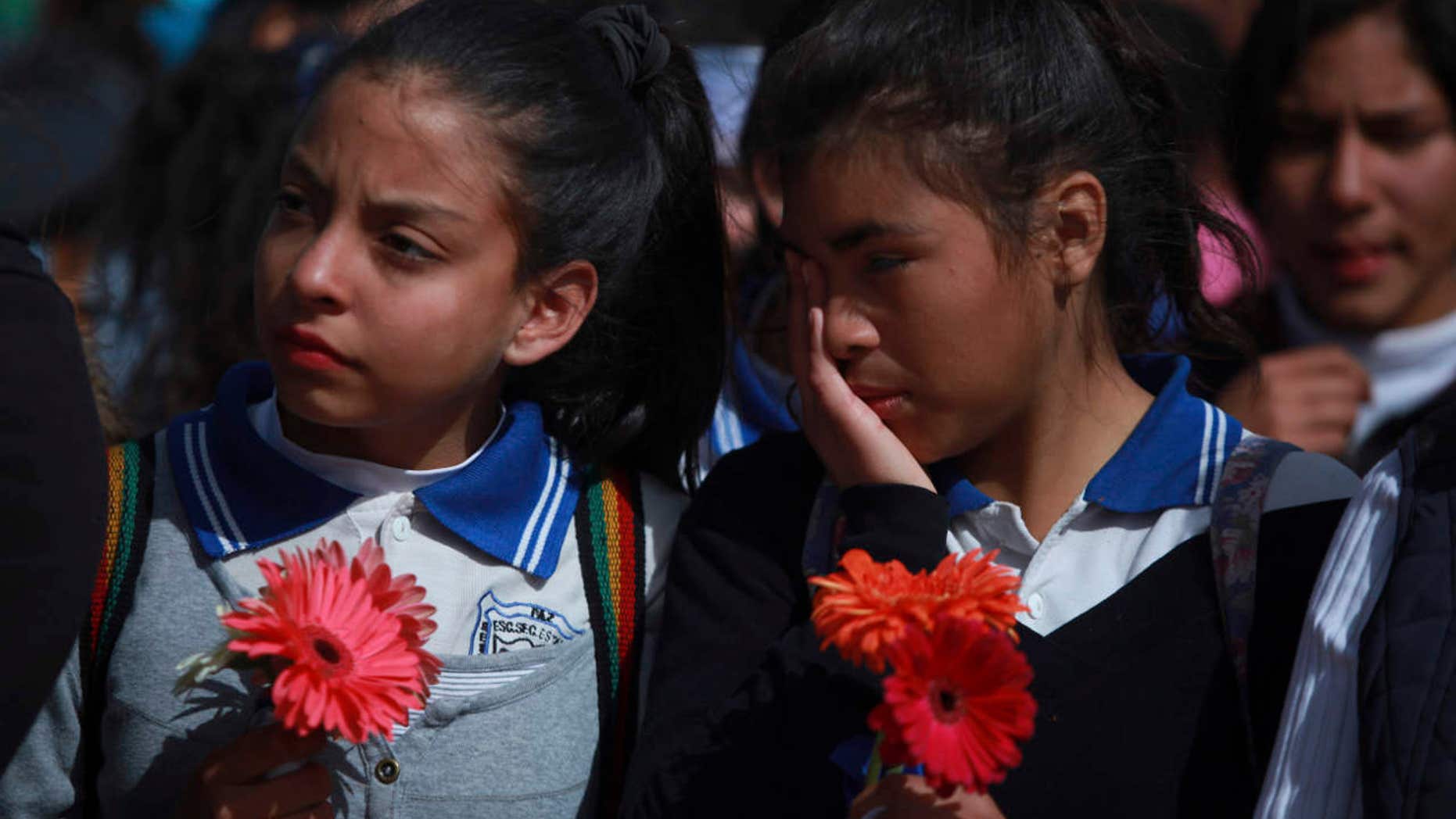 Mexicans students stand together as they form a symbolic human wall along the Rio Grande, which marks the border between Mexico and the U.S. in Ciudad Juarez, Friday, Feb. 17, 2017.