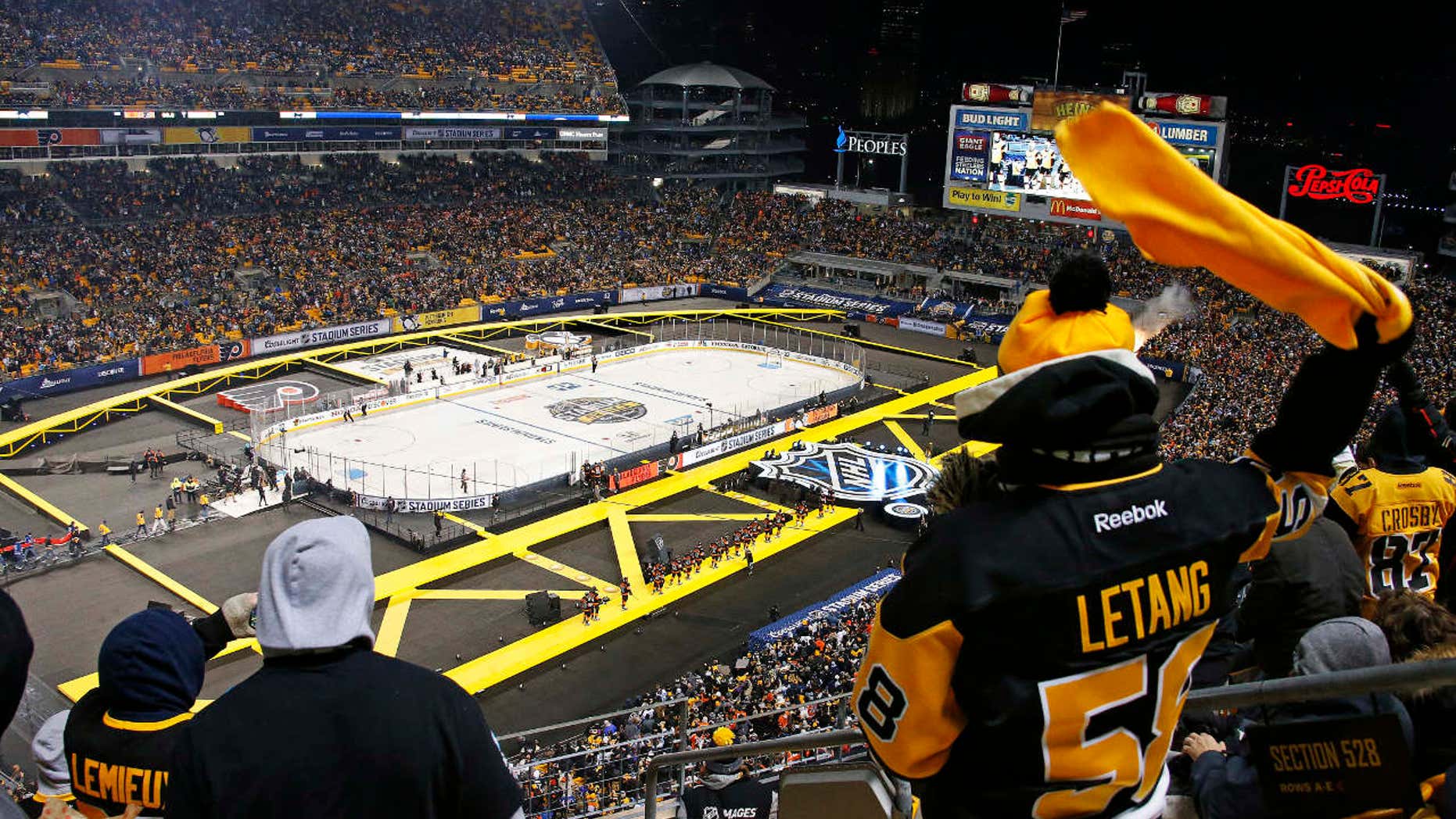 The Pittsburgh Penguins are introduced before an NHL Stadium Series hockey game at Heinz Field against the Philadelphia Flyers in Pittsburgh, Saturday, Feb. 25, 2017.
