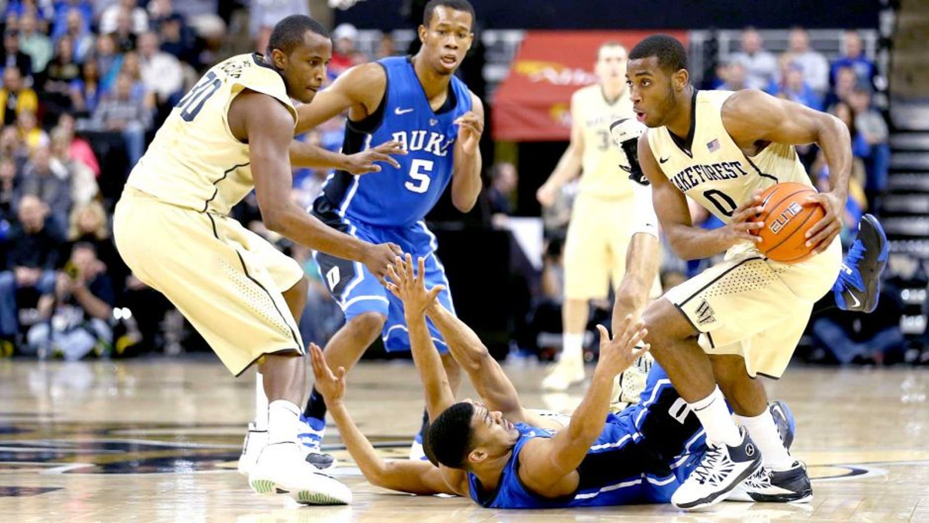 WINSTON-SALEM, NC - MARCH 05: Codi Miller-McIntyre #0 of the Wake Forest Demon Deacons steals the ball from Quinn Cook #2 of the Duke Blue Devils during their game against the Duke Blue Devils at Joel Coliseum on March 5, 2014 in Winston-Salem, North Carolina. (Photo by Streeter Lecka/Getty Images)