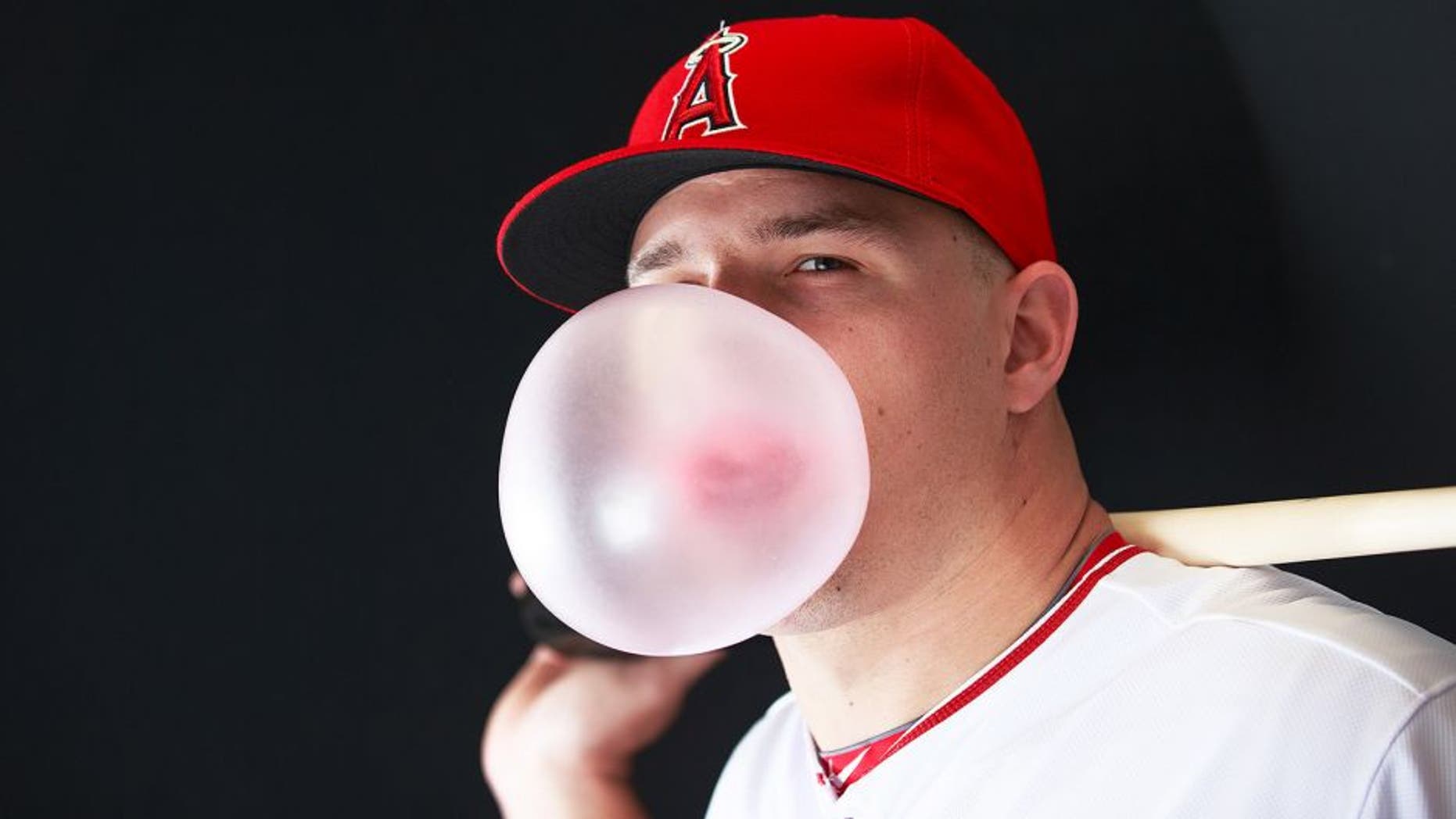 Feb 28, 2015; Tempe, AZ, USA; Los Angeles Angels outfields Mike Trout (27) blows a bubble gum bubble while he poses for a photo during photo day at Tempe Diablo Stadium. Mandatory Credit: Allan Henry-USA TODAY Sports