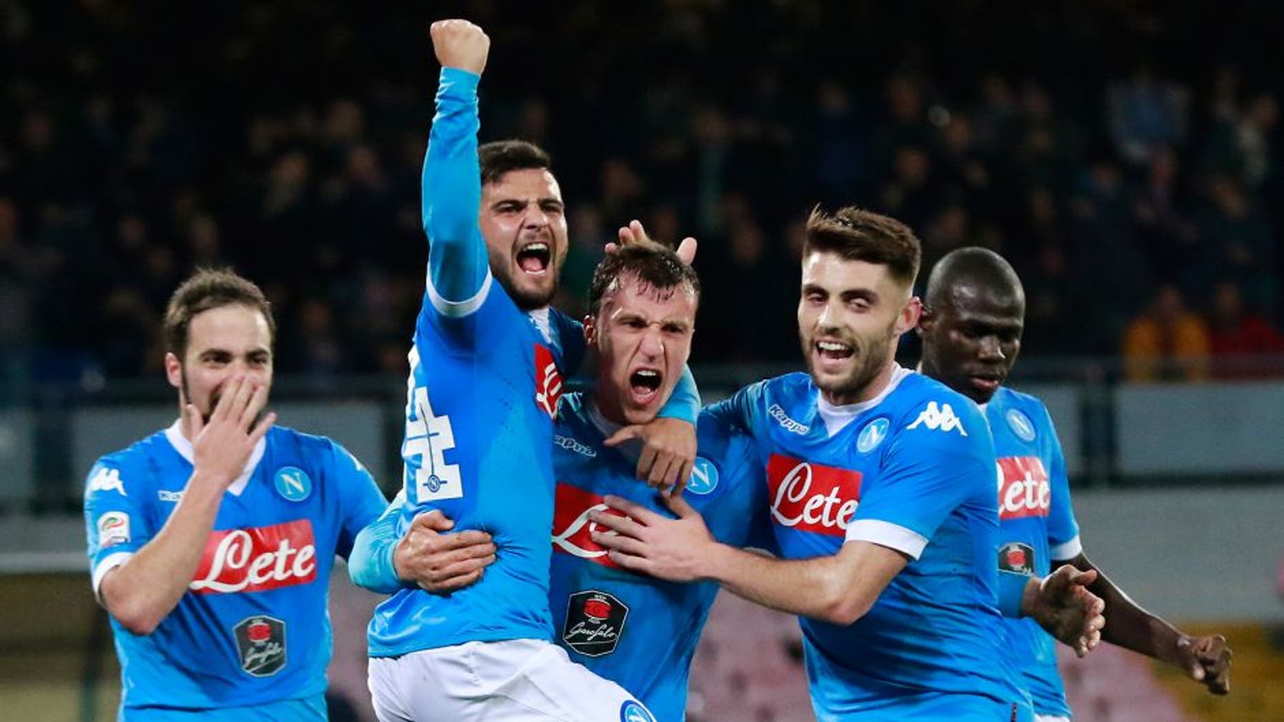 Napoli's Romanian defender Vlad Chiriches (C) celebrates with teammates after scoring a goal during the Italian Serie A football match between SSC Napoli and AC Chievo Verona on March 5, 2016 at the San Paolo stadium in Naples. / AFP / CARLO HERMANN (Photo credit should read CARLO HERMANN/AFP/Getty Images)