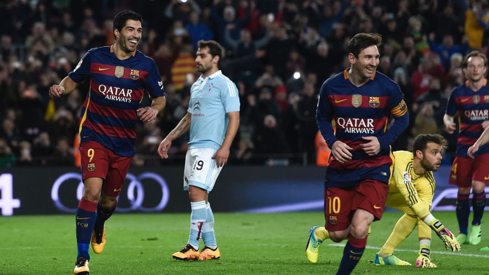 Barcelona's Uruguayan forward Luis Suarez (L) celebrates his goal with Barcelona's Argentinian forward Lionel Messi (3rd R) during the Spanish league football match FC Barcelona vs RC Celta de Vigo at the Camp Nou stadium in Barcelona on February 14, 2016. / AFP / JOSEP LAGO (Photo credit should read JOSEP LAGO/AFP/Getty Images)