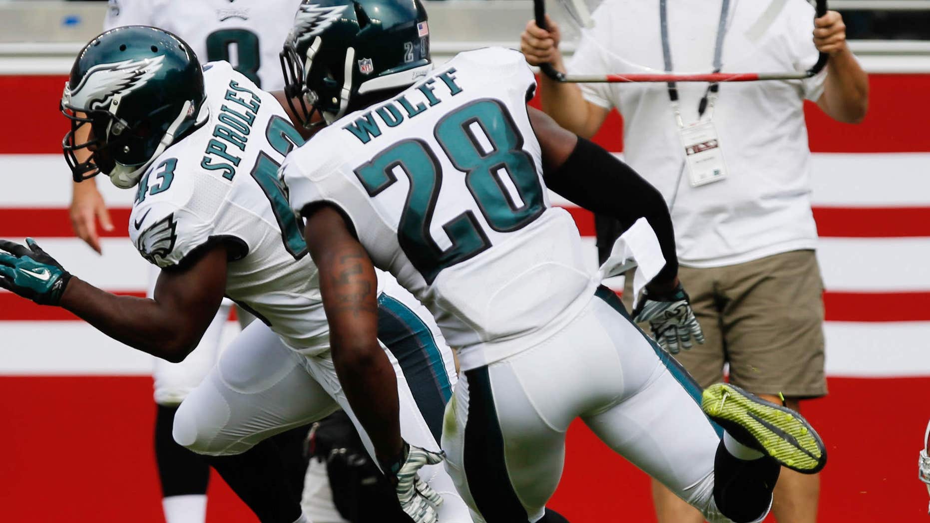 Sep 28, 2014; Santa Clara, CA, USA; Philadelphia Eagles running back Darren Sproles (43) escapes San Francisco 49ers defensive back L.J. McCray (31) with Philadelphia Eagles free safety Earl Wolff (28) as he runs for a touchdown on a punt return during the second quarter at Levi's Stadium.