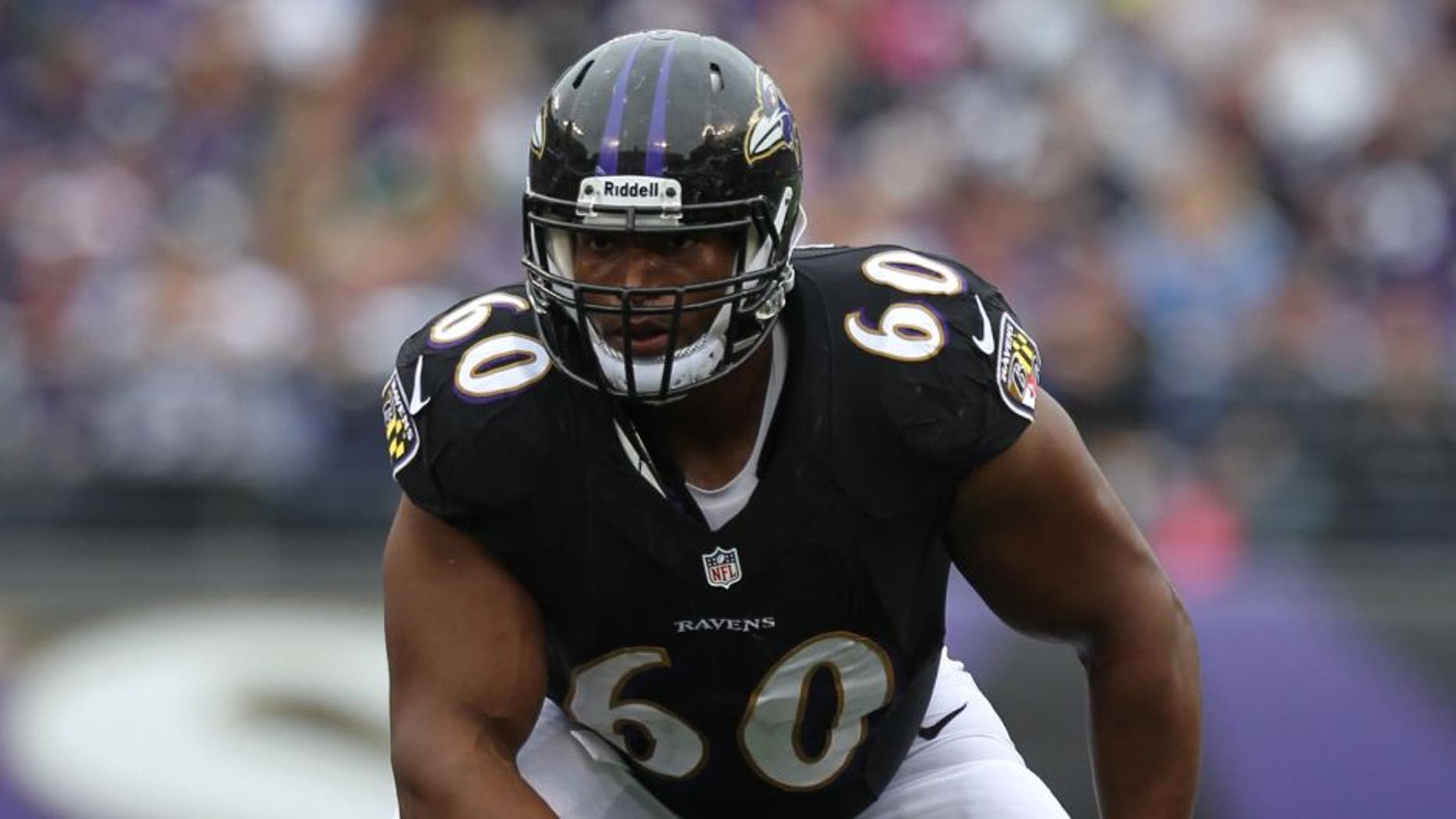Oct 13, 2013; Baltimore, MD, USA; Baltimore Ravens tackle Eugene Monroe (60) in action against the Green Bay Packers at M&T Bank Stadium. Mandatory Credit: Mitch Stringer-USA TODAY Sports