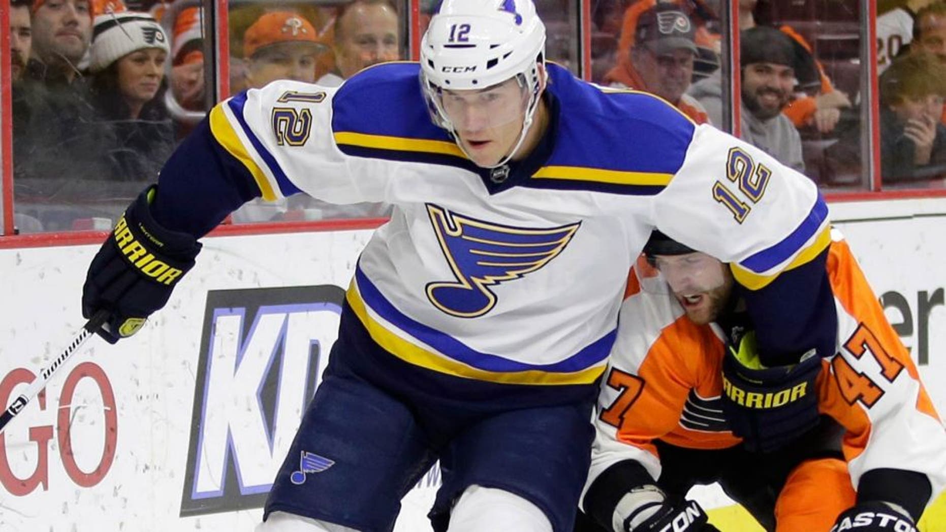 St. Louis Blues' Jori Lehtera (12), of Finland, keeps Philadelphia Flyers' Andrew MacDonald (47) away from the puck during the first period of an NHL hockey game, Thursday, March 5, 2015, in Philadelphia. (AP Photo/Matt Slocum)