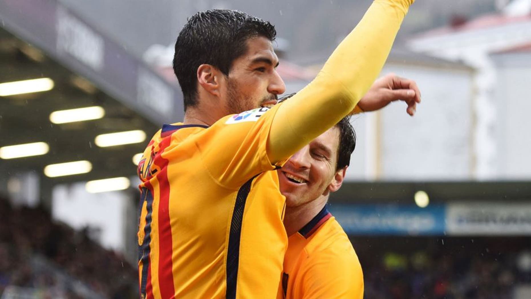 Barcelona's Uruguayan forward Luis Suarez (L) is congratulated by Argentinian forward Lionel Messi after scoring during the Spanish league football match SD Eibar vs FC Barcelona at the Ipurua stadium in Eibar on March 6, 2016. / AFP / ANDER GILLENEA (Photo credit should read ANDER GILLENEA/AFP/Getty Images)