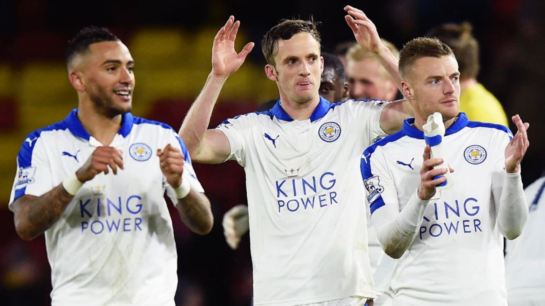 Leicester City's English defender Danny Simpson (L), Leicester City's Welsh midfielder Andy King (C) and Leicester City's English striker Jamie Vardy appluad the fans following the English Premier League football match between Watford and Leicester City at Vicarage Road Stadium in Watford, north of London on March 5, 2016. Leicester won the match 1-0. / AFP / OLLY GREENWOOD / RESTRICTED TO EDITORIAL USE. No use with unauthorized audio, video, data, fixture lists, club/league logos or 'live' services. Online in-match use limited to 75 images, no video emulation. No use in betting, games or single club/league/player publications. / (Photo credit should read OLLY GREENWOOD/AFP/Getty Images)