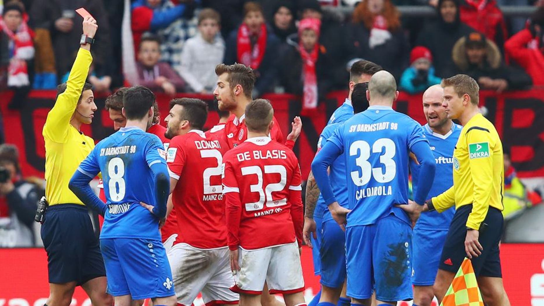 MAINZ, GERMANY - MARCH 06: Referee Benjamin Brand shows the red card to Giulio Donati of Mainz during the Bundesliga match between 1. FSV Mainz 05 and SV Darmstadt 98 at Coface Arena on March 6, 2016 in Mainz, Germany. (Photo by Alex Grimm/Bongarts/Getty Images)