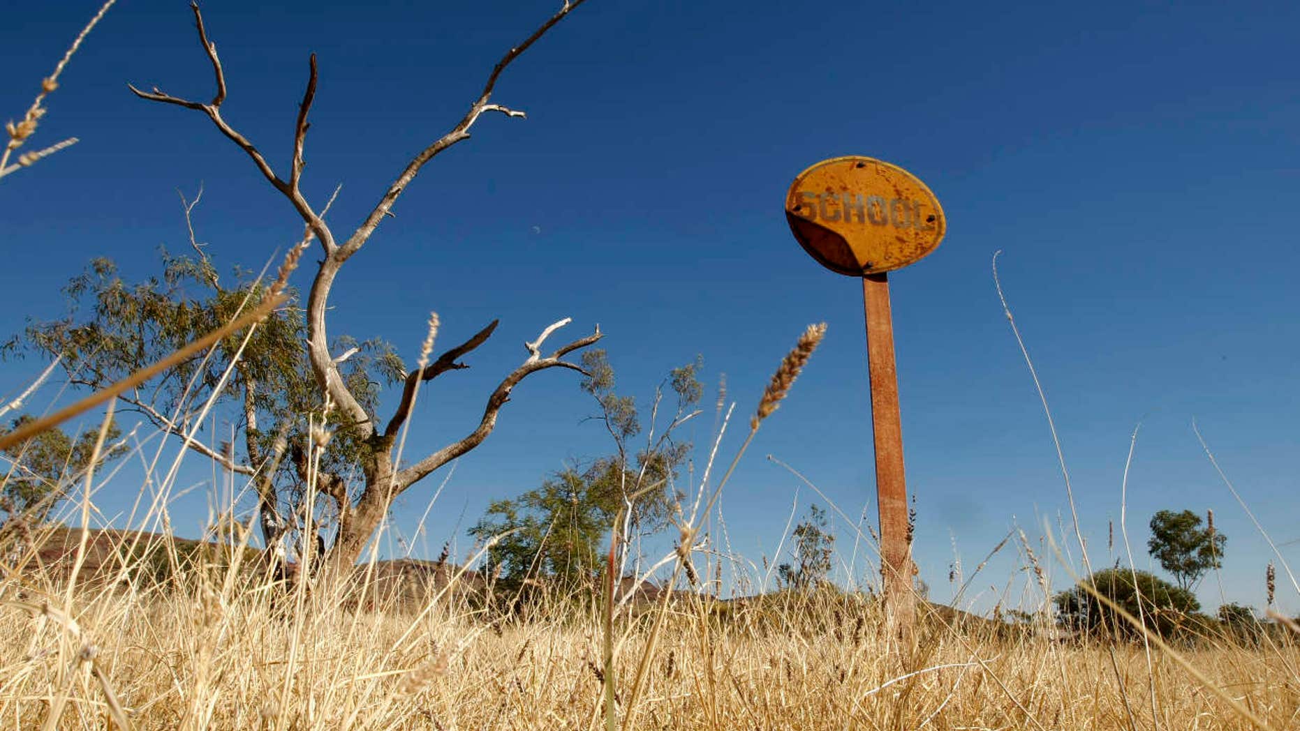 A rusting sign indicating where a school once operated stands in the former town of Wittenoom, about 870 miles north of the West Australian city of Perth.