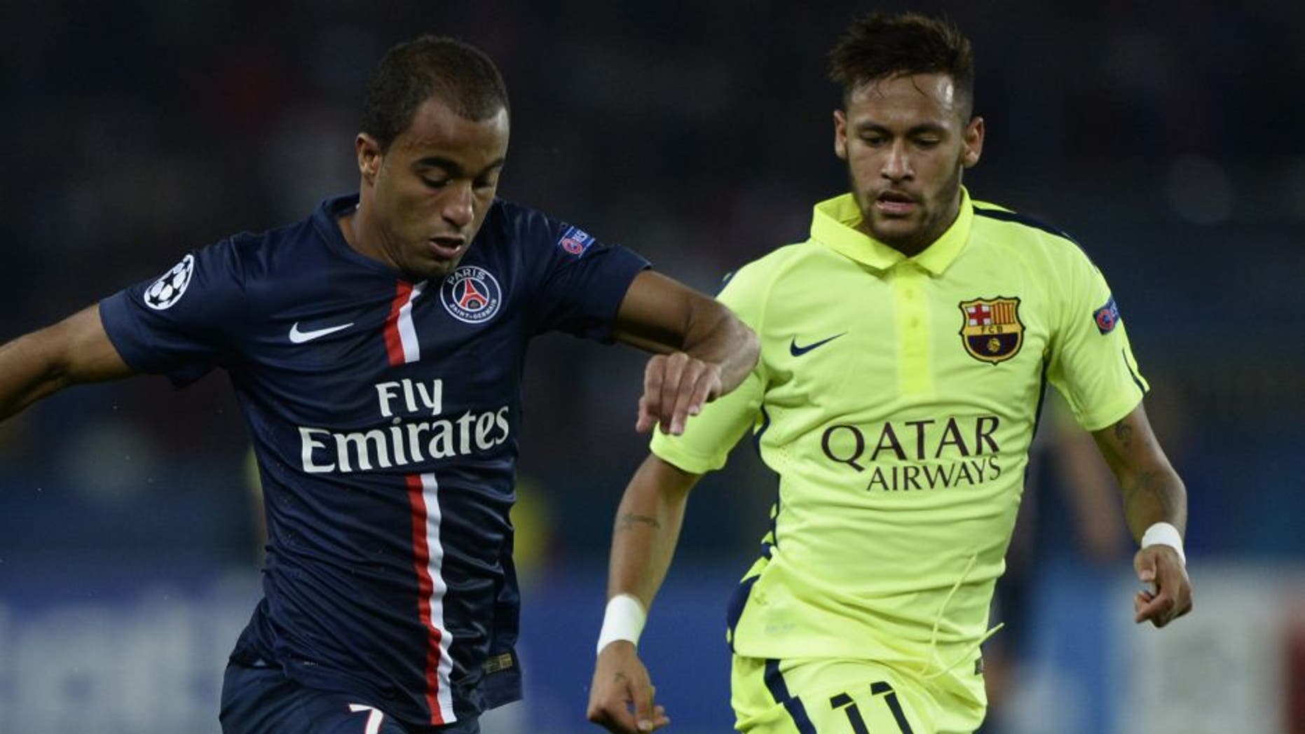 Paris' Brazilian forward Lucas Moura (L) vies with Barcelona's Brazilian forward Neymar during the UEFA Champions League football match Paris Saint-Germain (PSG) vs Barcelona (FCB) on September 30, 2014 at the Parc des Princes stadium in Paris. AFP PHOTO / FRANCK FIFE (Photo credit should read FRANCK FIFE/AFP/Getty Images)