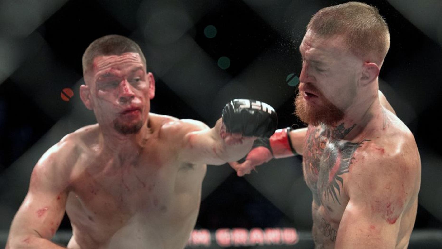LAS VEGAS, NV - MARCH 5: (L-R) Nate Diaz punches Conor McGregor in their welterweight bout during the UFC 196 in the MGM Grand Garden Arena on March 5, 2016 in Las Vegas, Nevada. (Photo by Brandon Magnus/Zuffa LLC/Zuffa LLC via Getty Images)