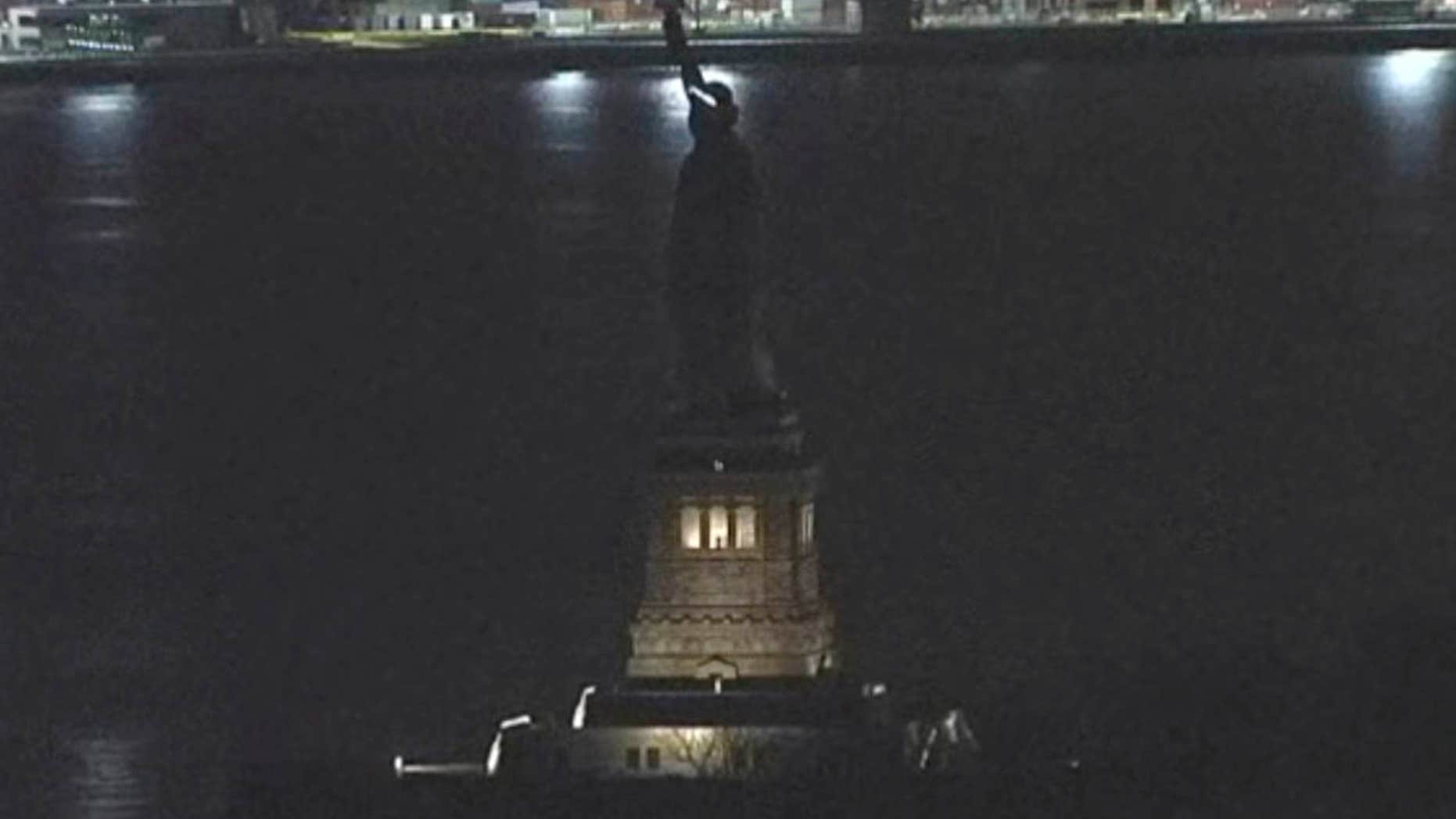 This Tuesday, March 7, 2017, still image taken from video shows the Statue of Liberty in New York. For several hours, Lady Liberty didn't shine so brightly.