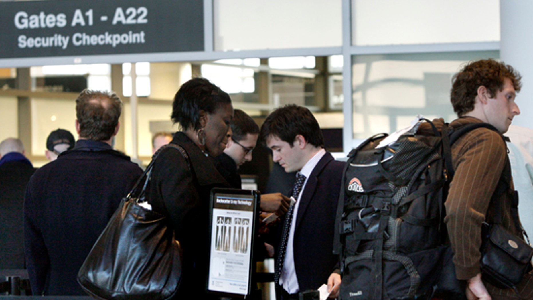 In this March 8, 2010 photo, travelers wait in line prior to entering a security checkpoint at Logan International Airport in Boston. (AP)