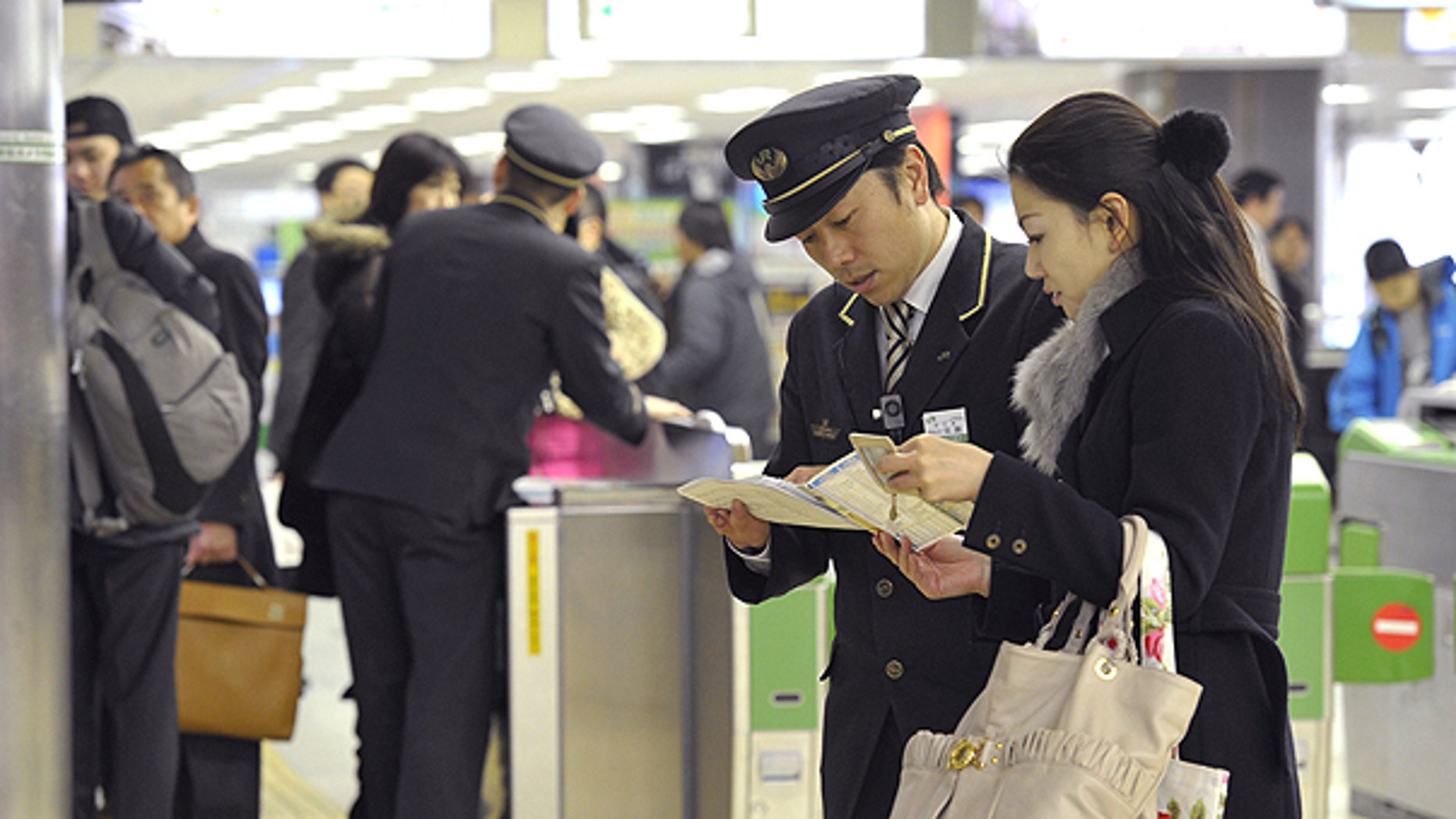 March 9: Japan Railway Sendai Station staff help stranded bullet train passengers as the high-speed train service is suspended at the station in Sendai, north of Tokyo, following a magnitude 7.3 earthquake hit northern Japan.