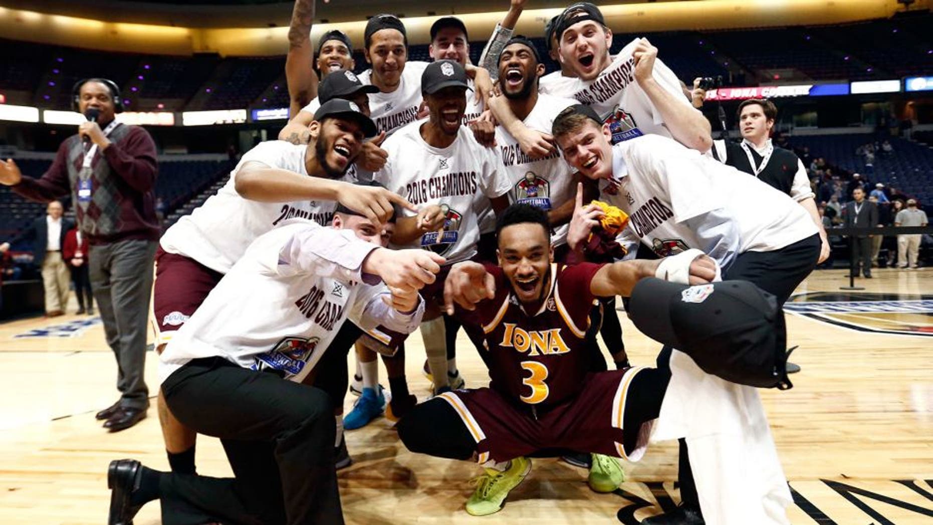 Mar 7, 2016; Albany, NY, USA; Iona Gaels guard Ibn Muhammad (3) and the rest of the team celebrate after defeating the Monmouth Hawks in the MAAC conference tournament finals at Times Union Center. Mandatory Credit: Mark L. Baer-USA TODAY Sports