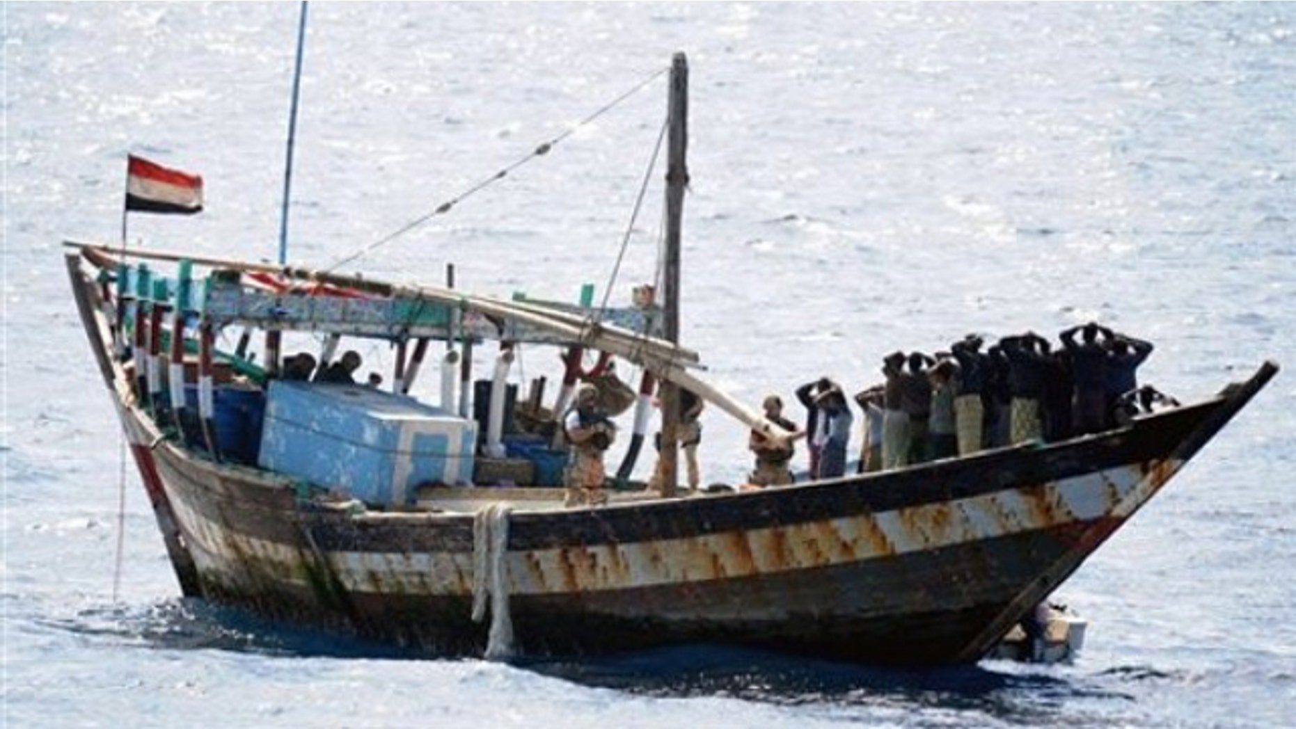 Feb. 16: In this image made available by the Ministry of Defence in London, a naval boarding party from HMS Cornwall guard Somali pirates after their dhow was boarded in the Indian Ocean.
