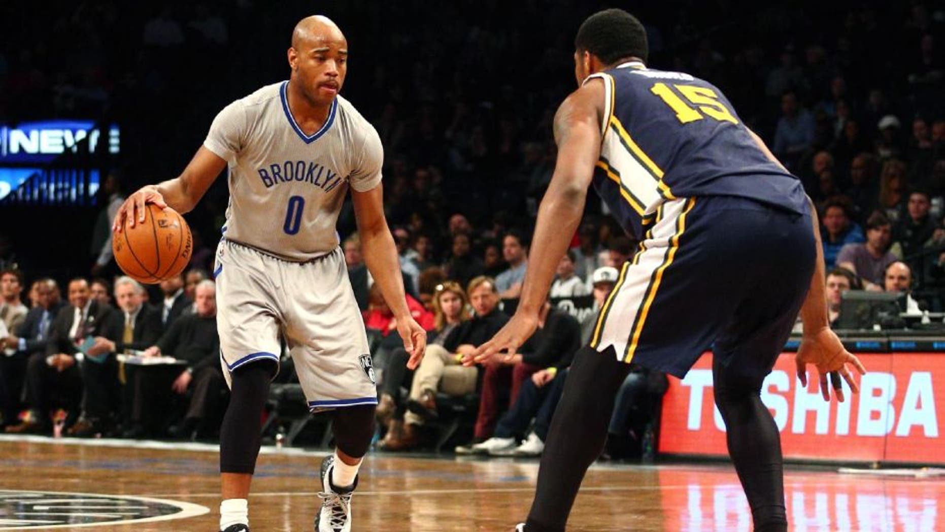 Mar 8, 2015; Brooklyn, NY, USA; Brooklyn Nets point guard Jarrett Jack (0) controls the ball against Utah Jazz power forward Derrick Favors (15) during the second quarter at Barclays Center. Mandatory Credit: Brad Penner-USA TODAY Sports