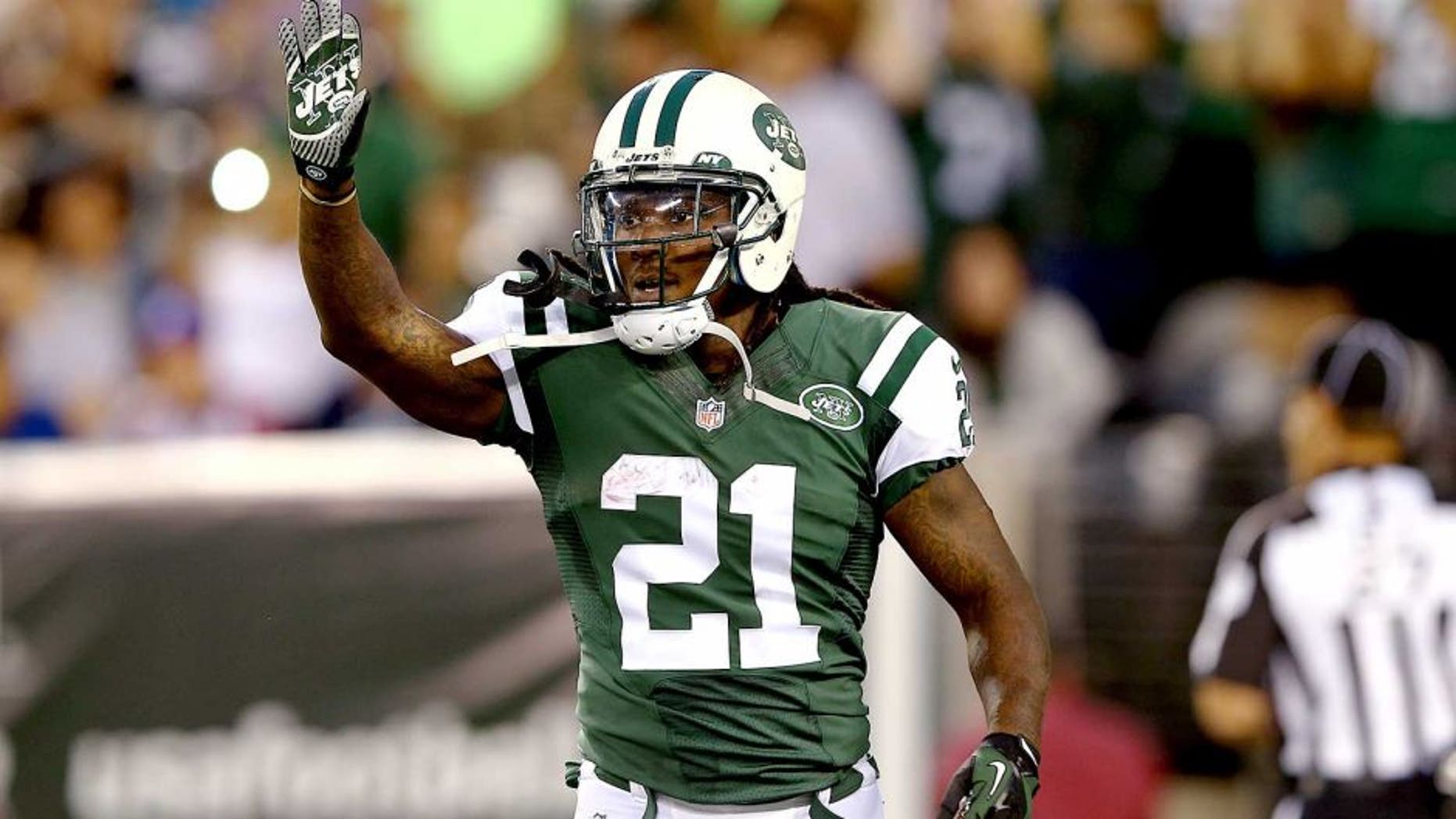 EAST RUTHERFORD, NJ - AUGUST 07: Running back Chris Johnson #21 of the New York Jets celebrates a touchdown against the Indianapolis Colts in the second quarter during a preseason game at MetLife Stadium on August 7, 2014 in East Rutherford, New Jersey. (Photo by Elsa/Getty Images)