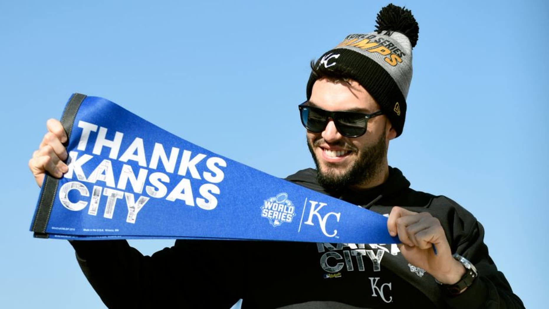 KANSAS CITY, MO -NOVERMBER 3: Eric Hosmer #35 of the Kansas City Royals holds up a pennant thanking fans during a parade to celebrate their World Series victory on November 3, 2015 in Kansas City, Missouri. (Photo by Ed Zurga/Getty Images)