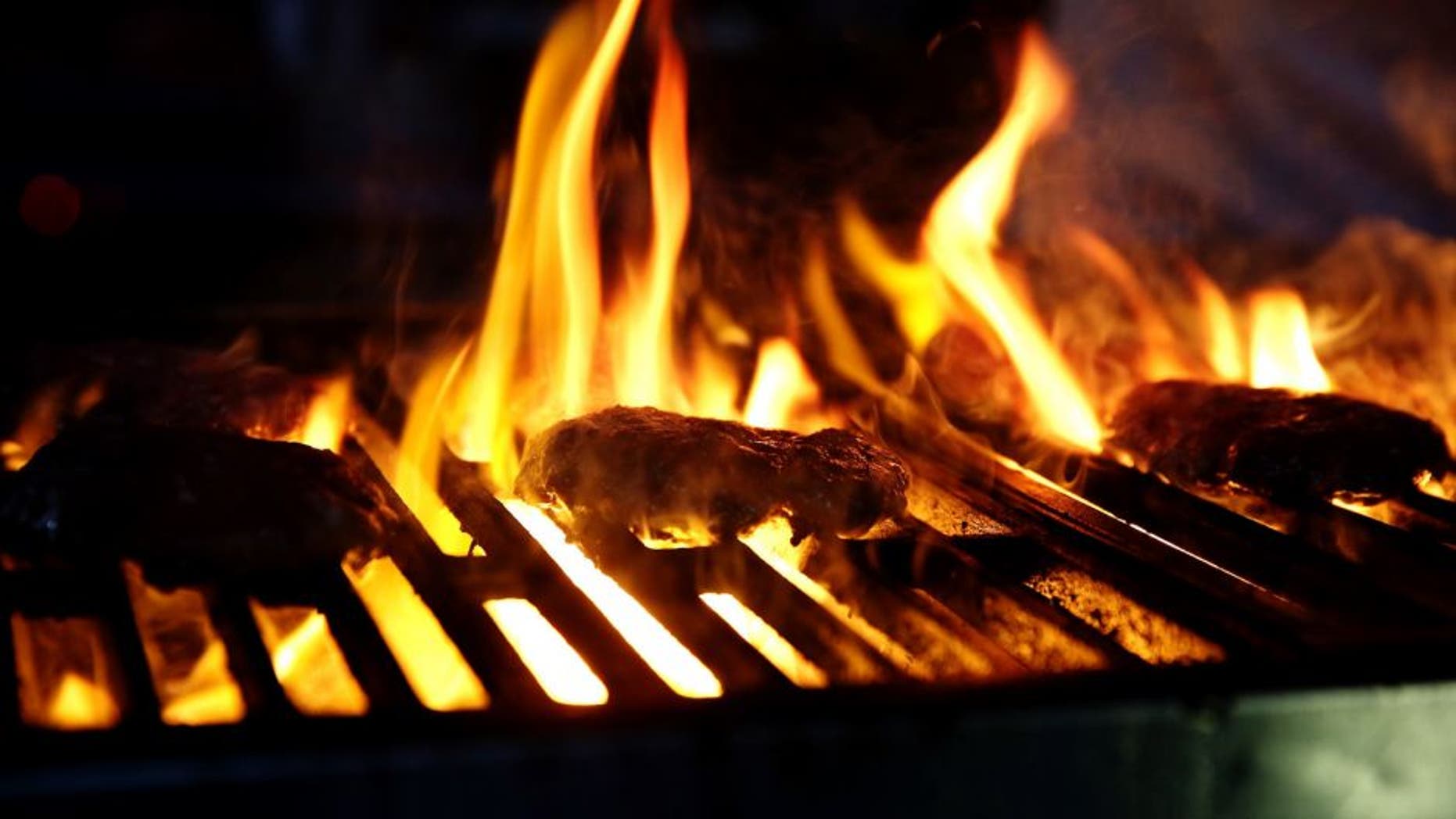 NEW YORK, NY - OCTOBER 16: Burgers cook on a grill during the Blue Moon Burger Bash presented by Pat LaFrieda Meats hosted by Rachael Ray - Food Network & Cooking Channel New York City Wine & Food Festival presented by FOOD & WINE at Pier 92 on October 16, 2015 in New York City. (Photo by Neilson Barnard/Getty Images for NYCWFF)