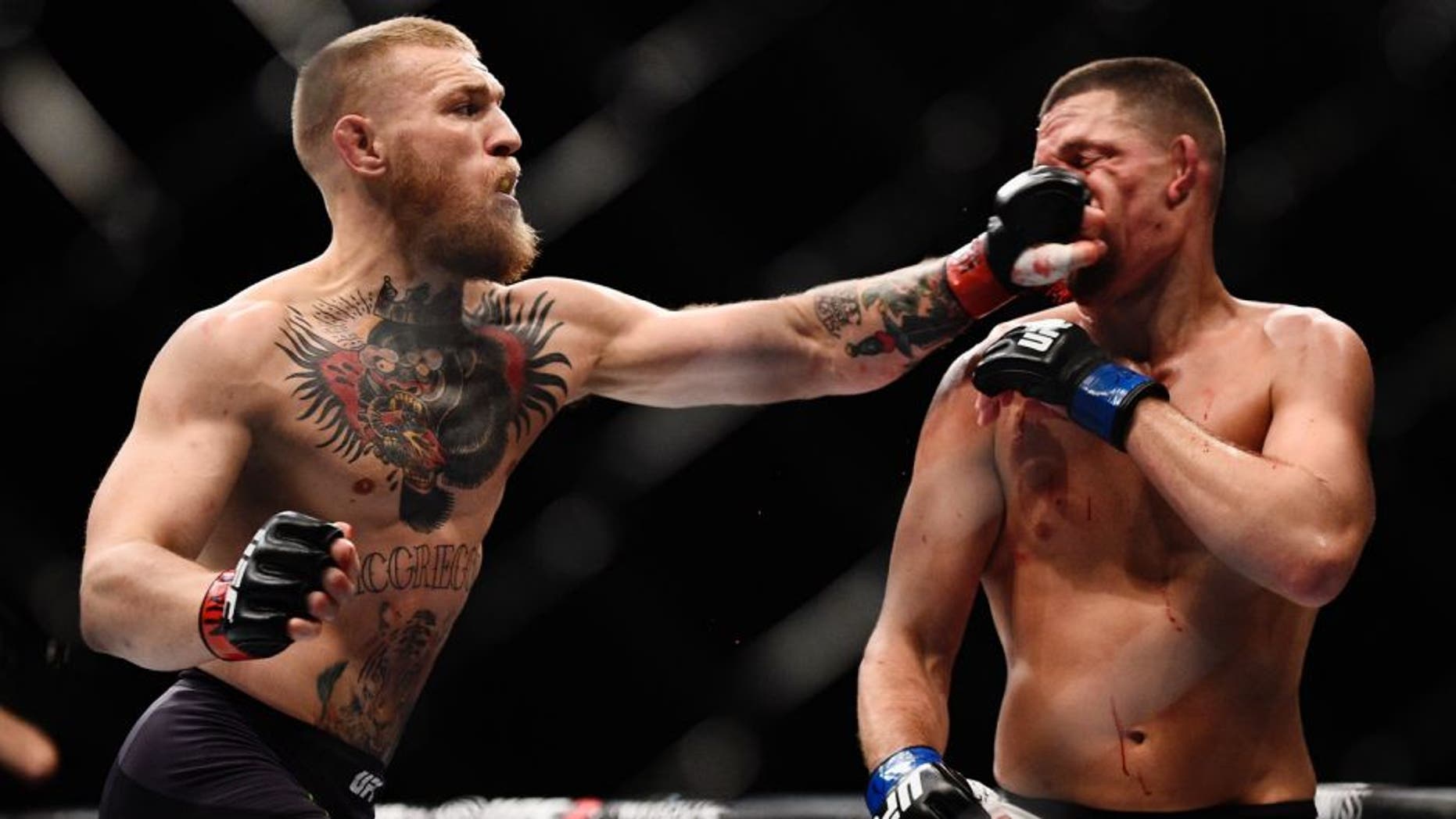LAS VEGAS, NV - MARCH 05: (L-R) Conor McGregor of Ireland punches Nate Diaz during the UFC 196 event inside MGM Grand Garden Arena on March 5, 2016 in Las Vegas, Nevada. (Photo by Jeff Bottari/Zuffa LLC/Zuffa LLC via Getty Images)