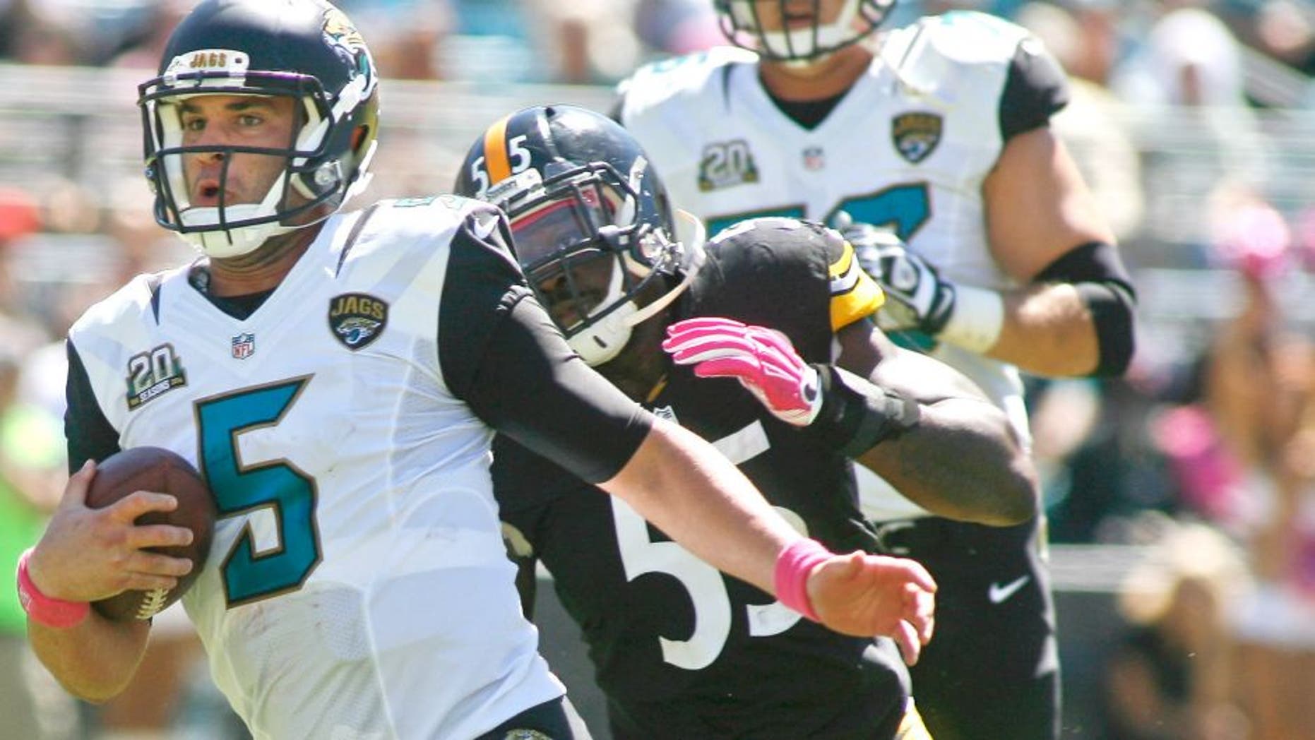 Oct 5, 2014; Jacksonville, FL, USA; Jacksonville Jaguars quarterback Blake Bortles (5) runs past Pittsburgh Steelers outside linebacker Arthur Moats (55) for a first down in the first quarter of their game at EverBank Field. Mandatory Credit: Phil Sears-USA TODAY Sports